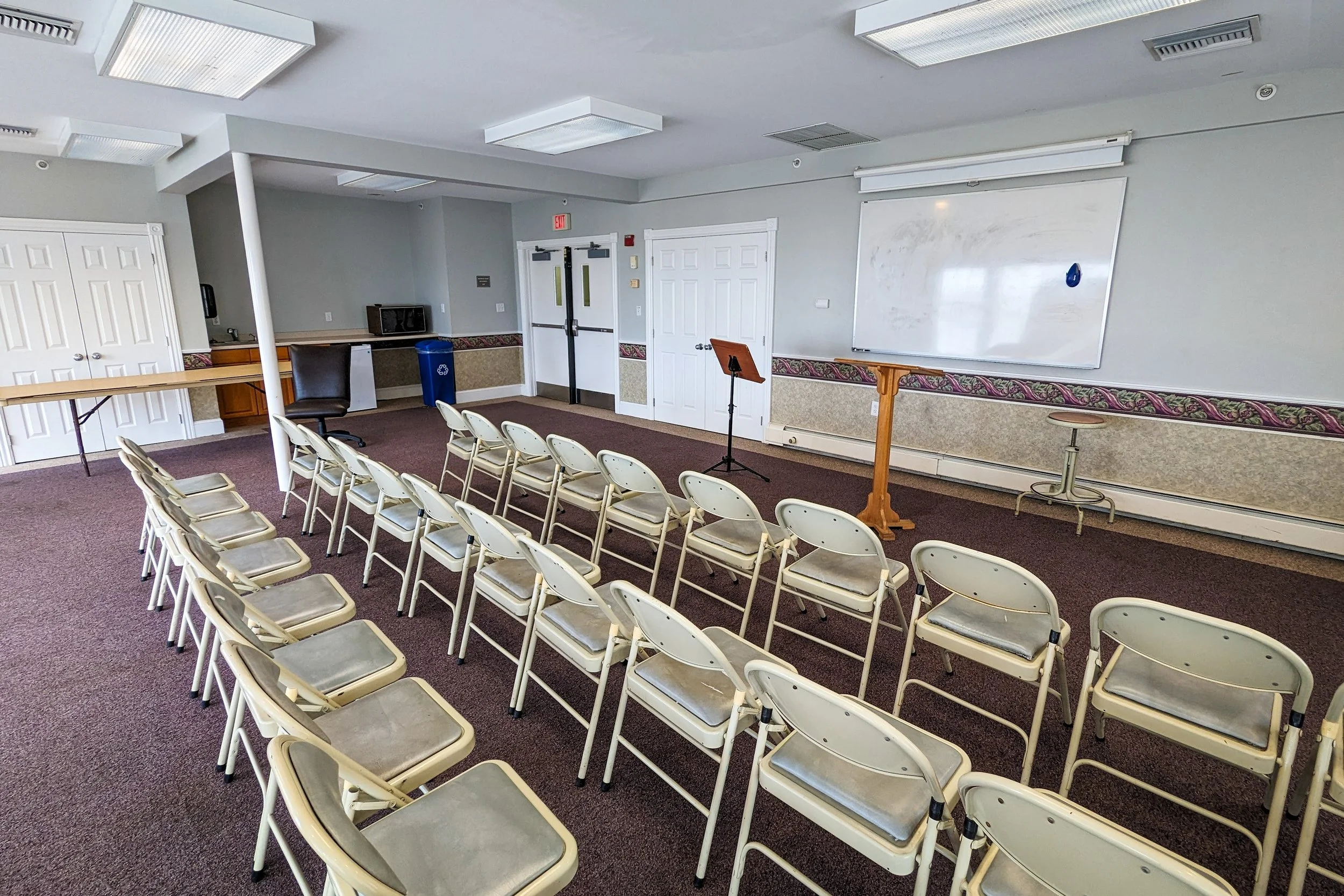 Small meeting room with podium and chairs