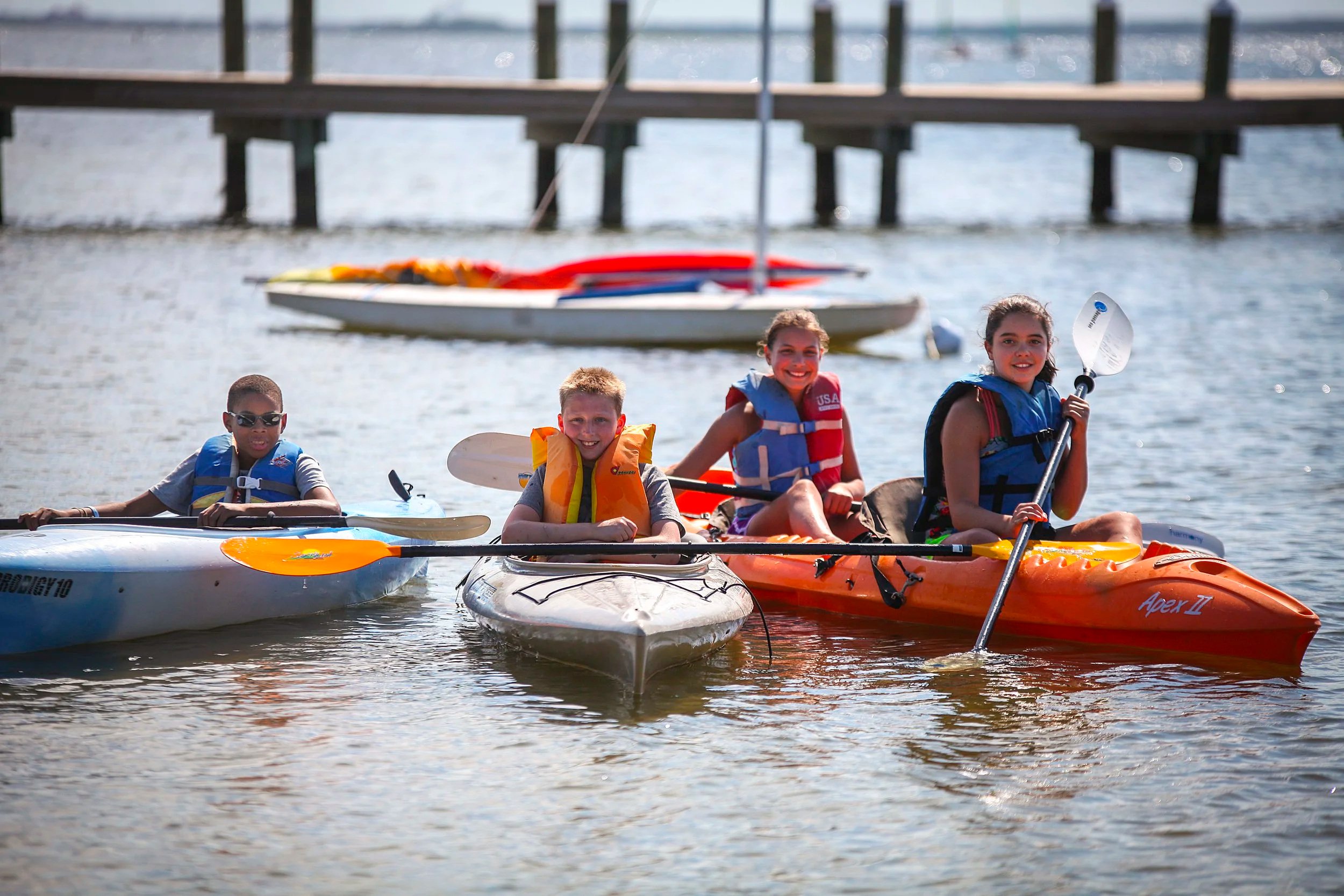 Kids in kayaks at the beach