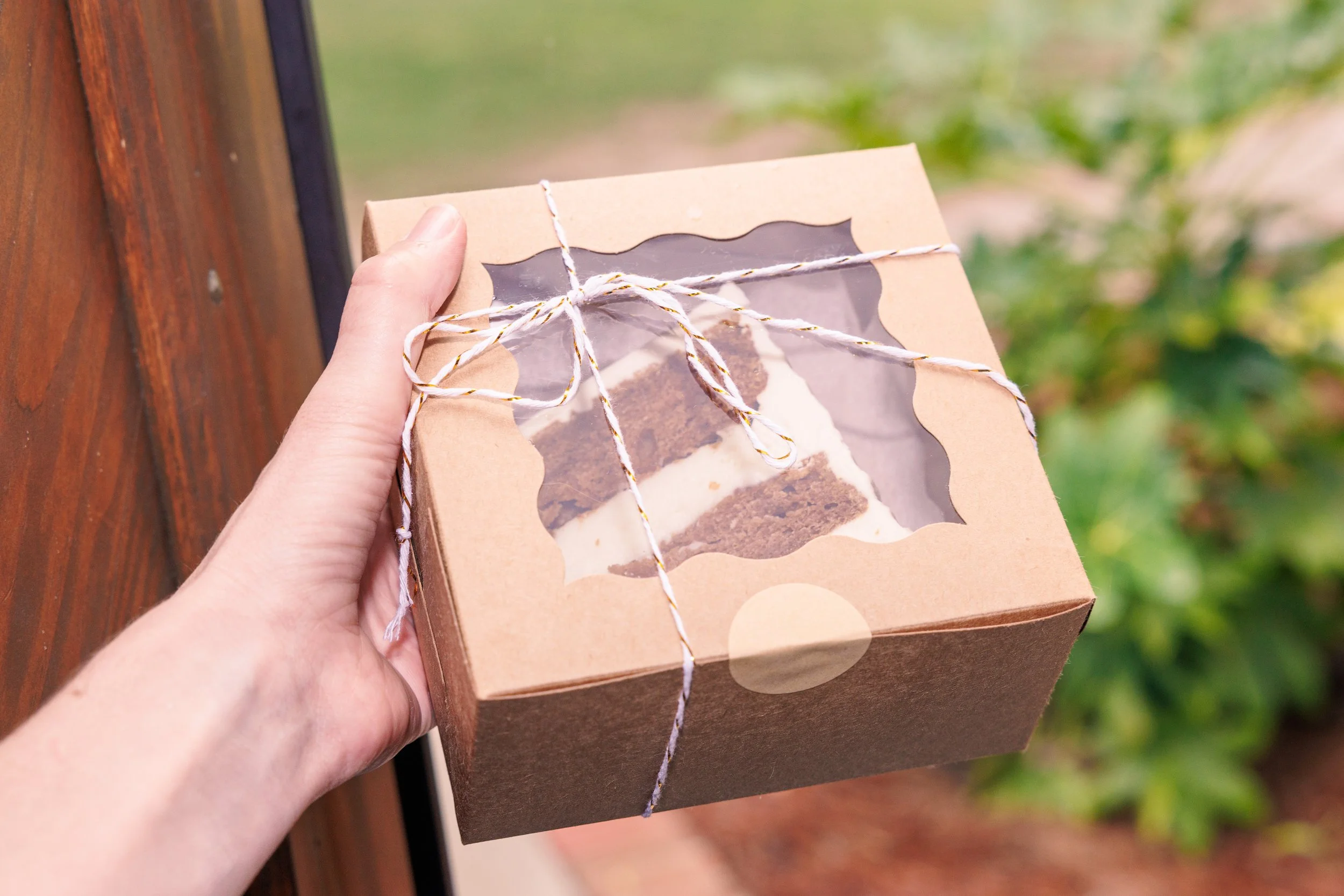 Dessert item in a to go box headed out the door.