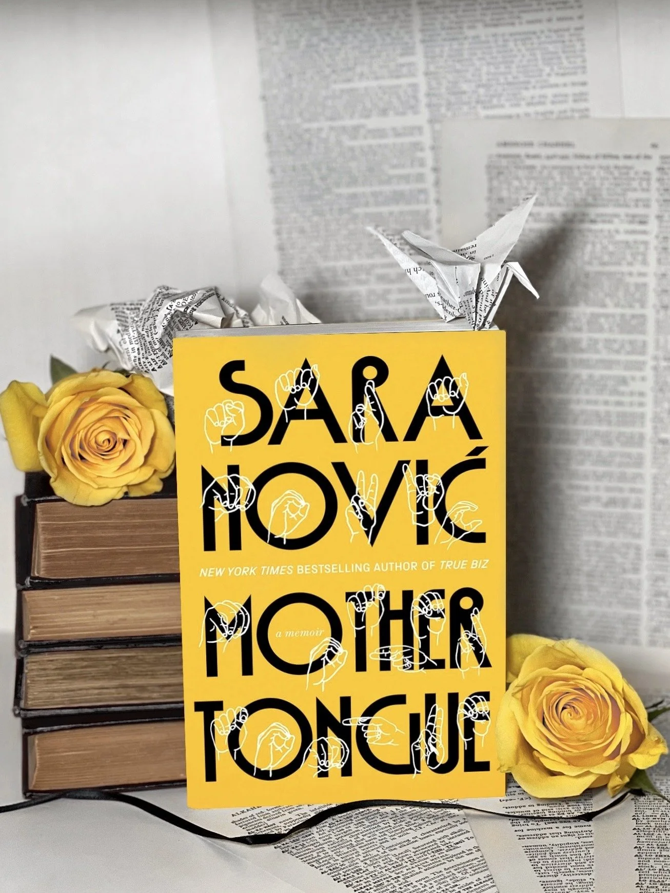 a bright yellow book with large black text spelling out “Sara Nović, Mother Tongue” with white silhouette illustrations of the corresponding ASL signs over each letter.