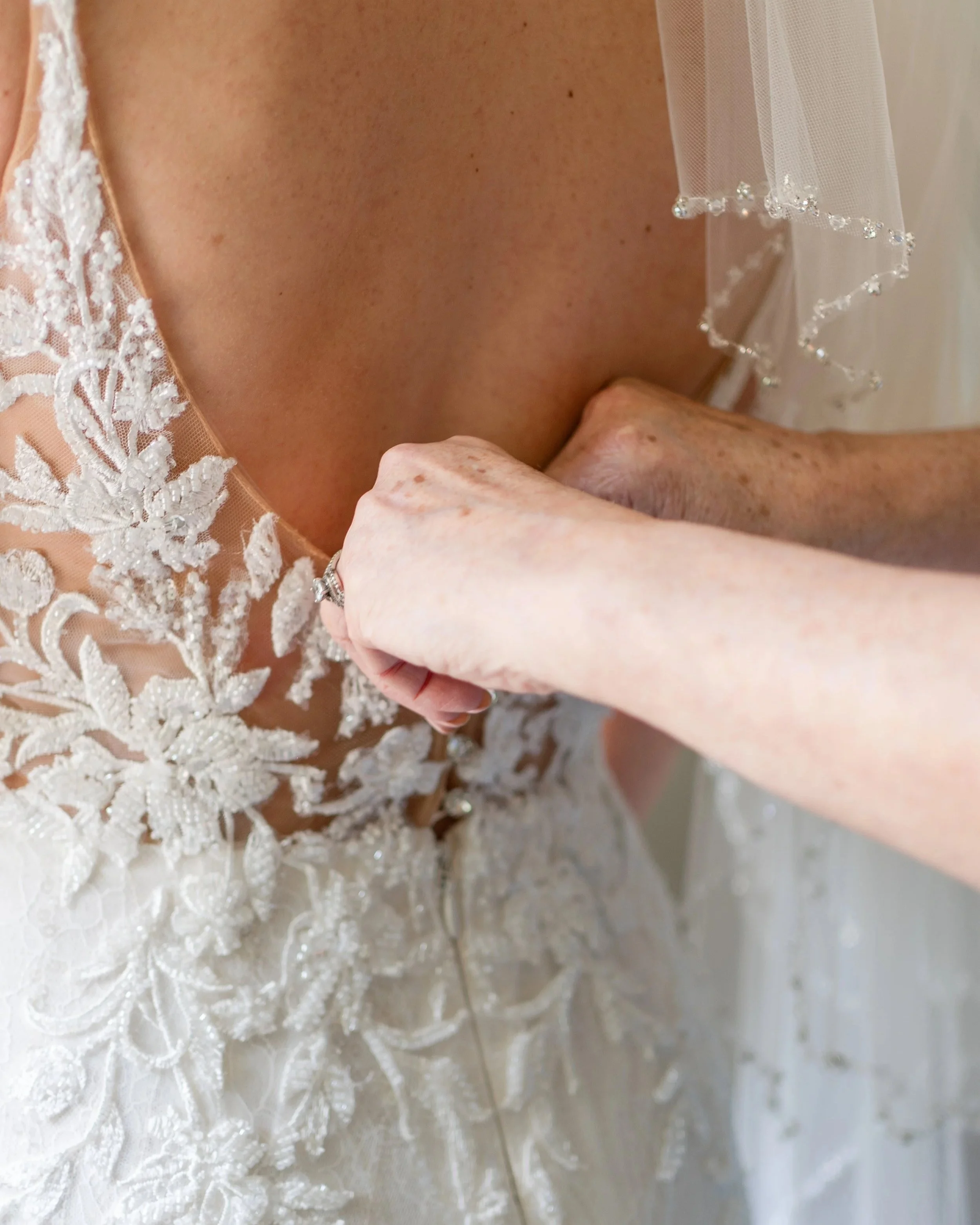 Close-up of a bride getting dressed