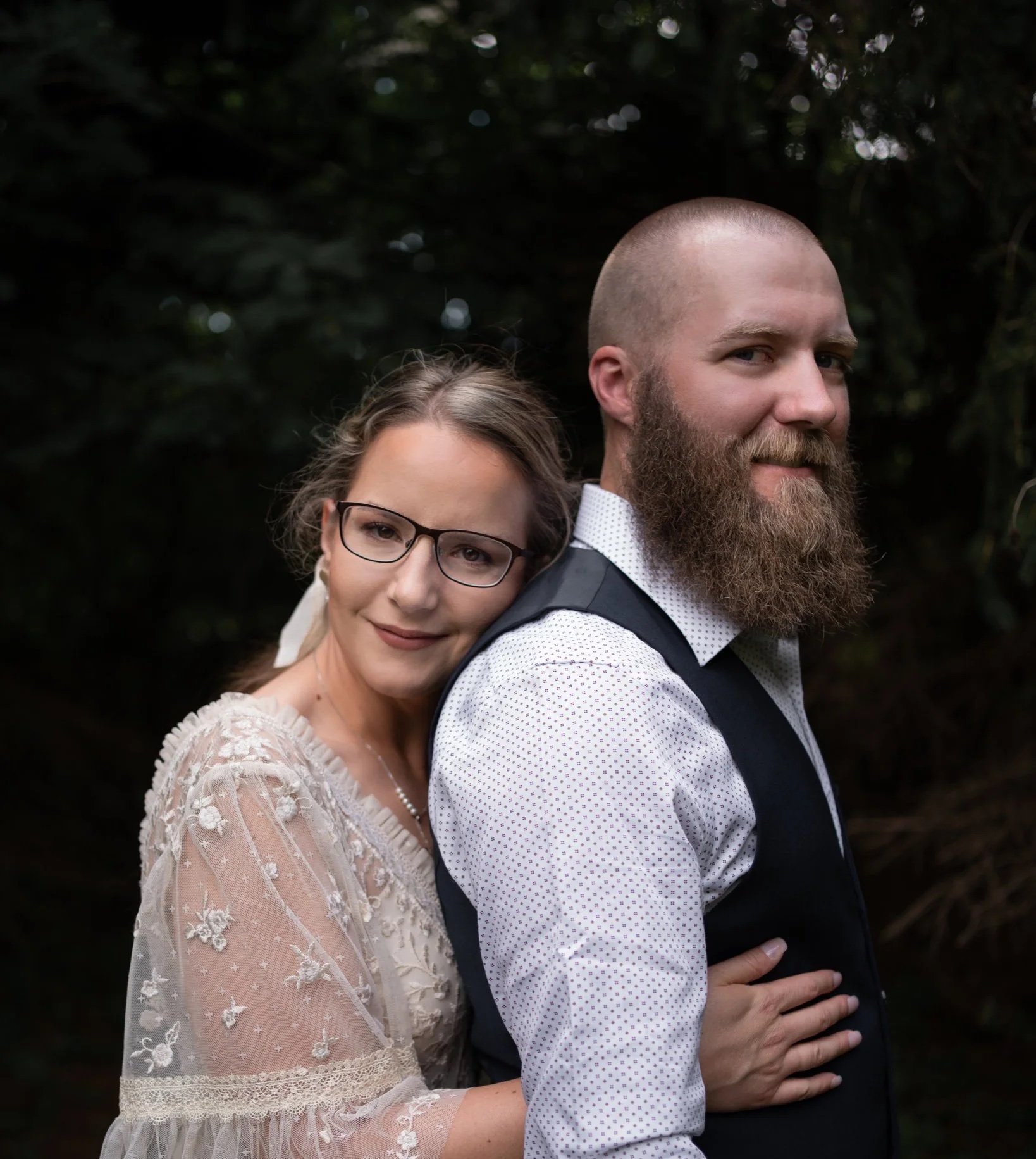 Engagement session - the man kissing the woman's cheek.