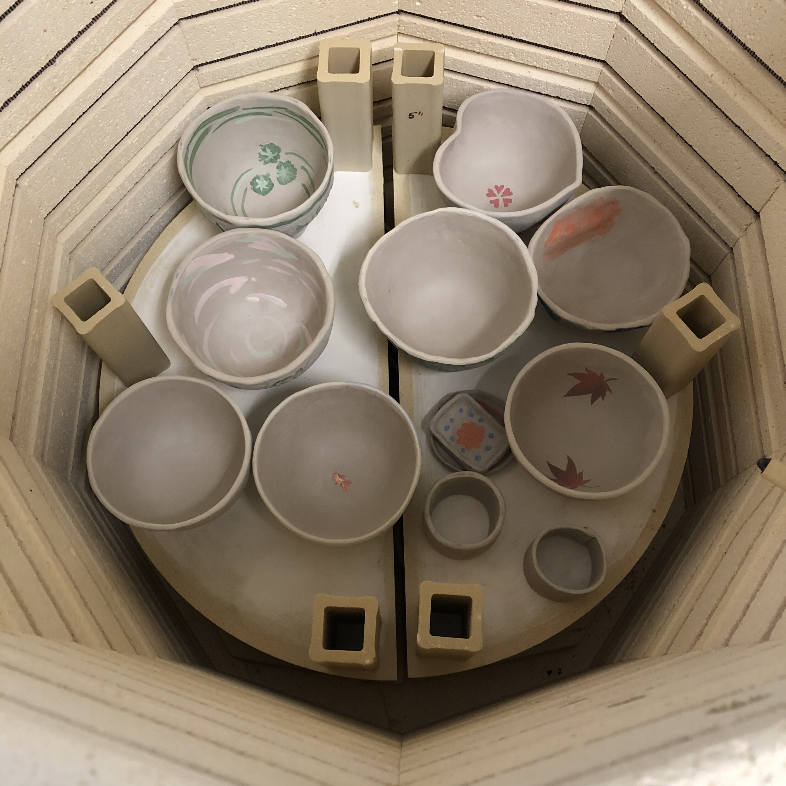 Tea bowls in the kiln before firing.