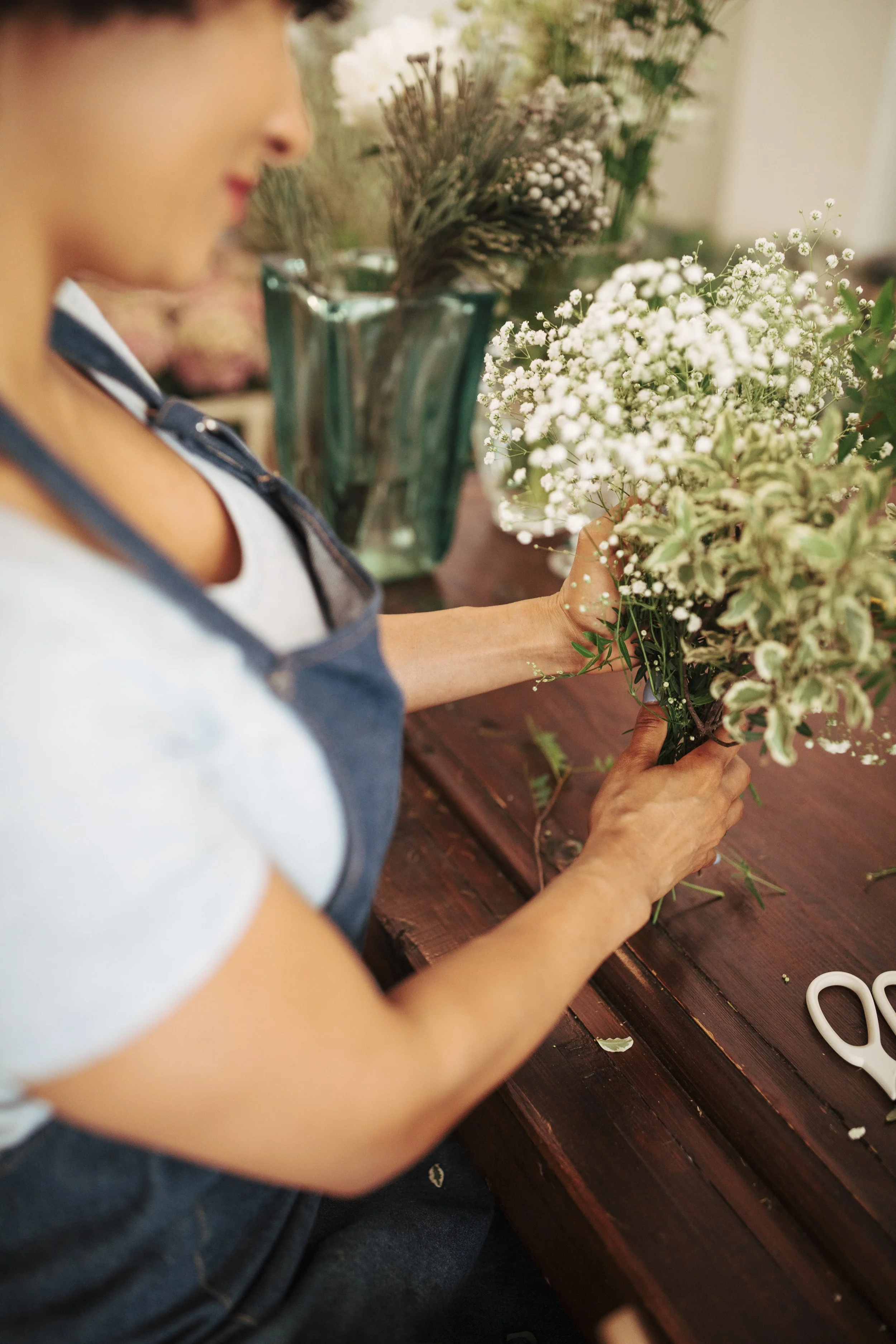 close-up-female-florist-s-hand-white-flower-plants.jpg