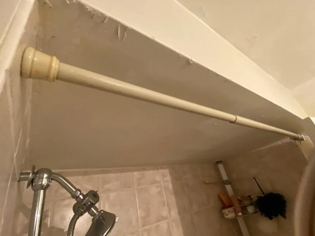 Ugly Bathroom Before with dated tile, bulkhead and peeling paint