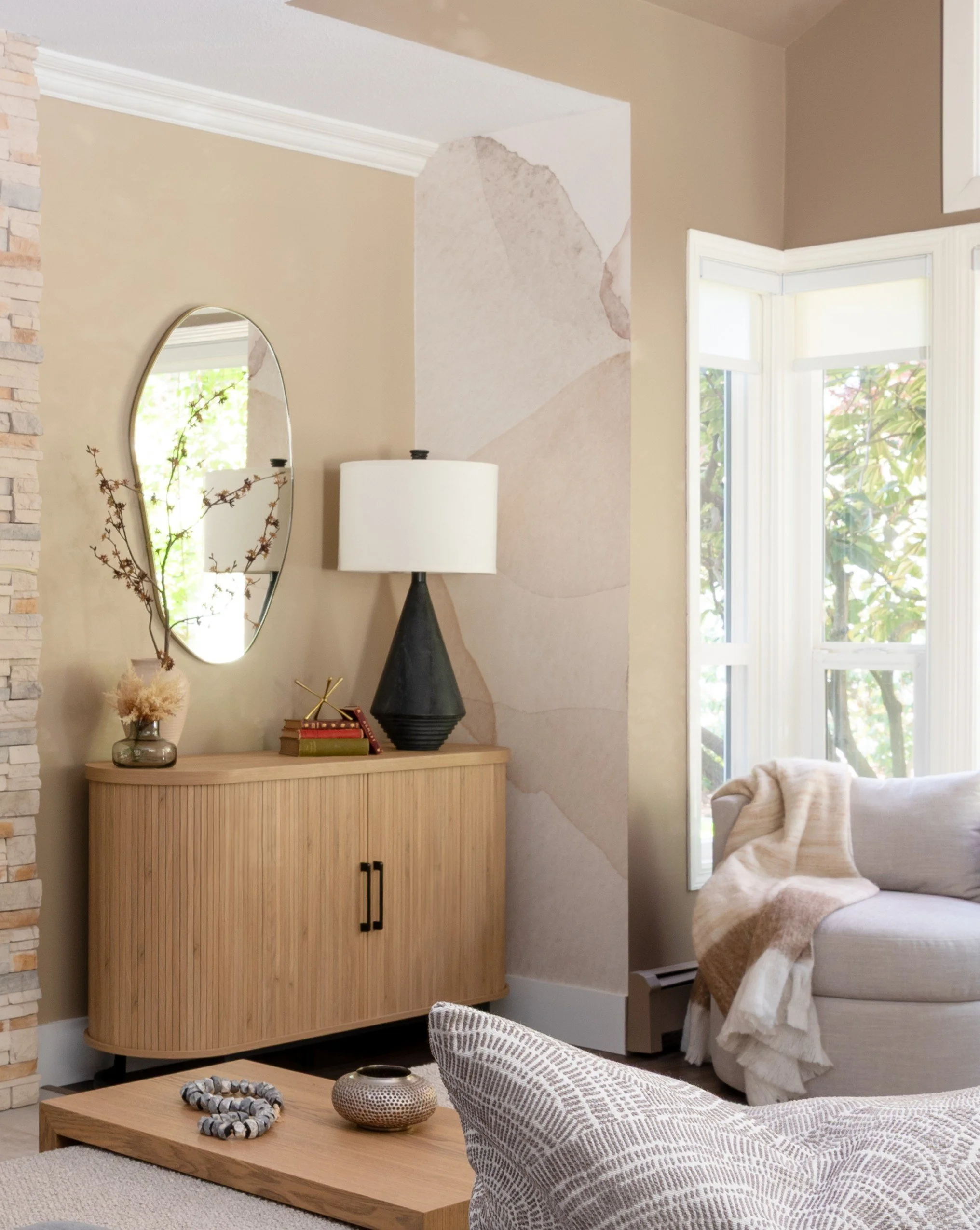 Showcasing the newly painted beige wall behind the new white oak tabmour console table. The side wall has wallpaper and the other side has brick fireplace. Three different textures all working together to make the space feel cohesive.
