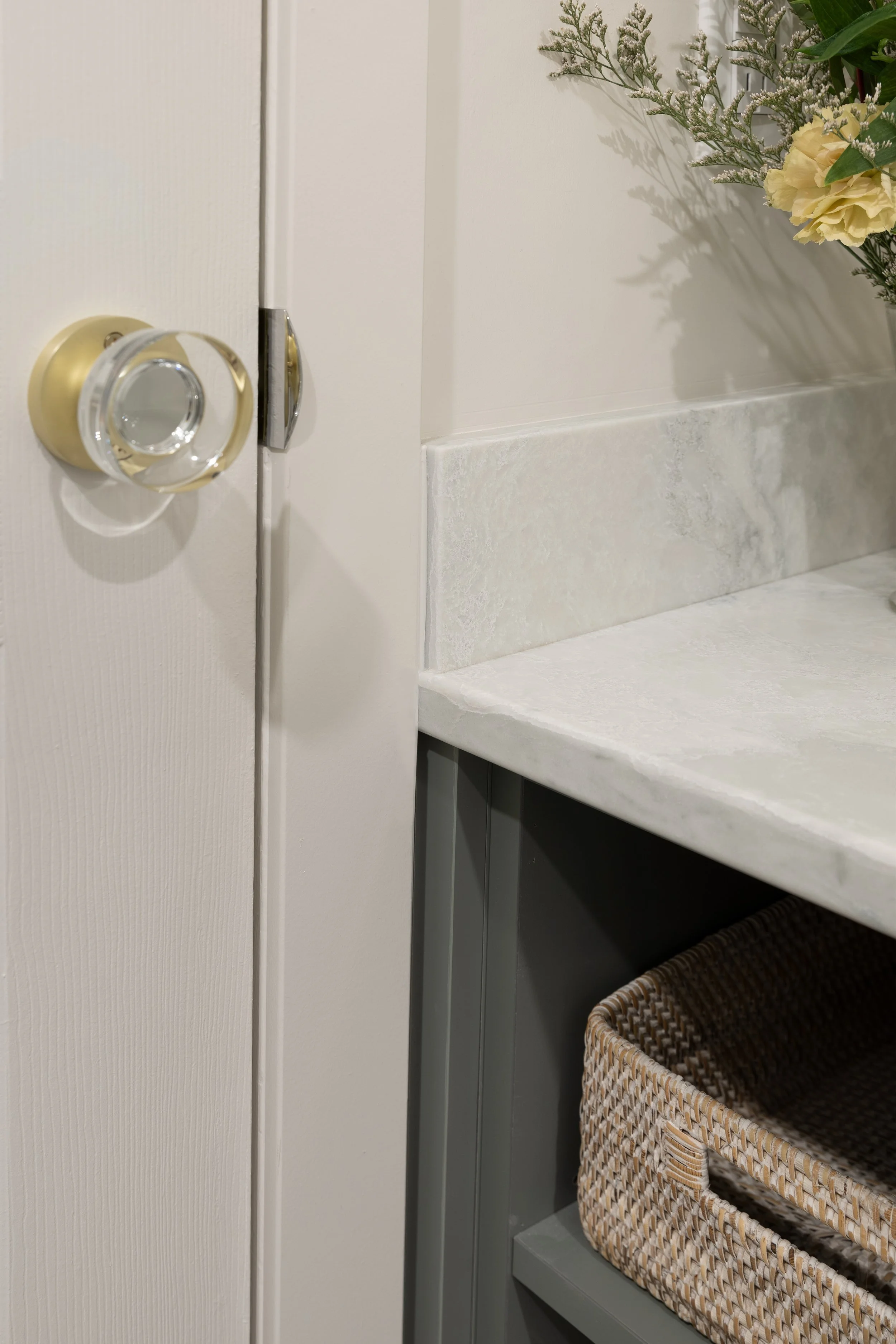 Bathroom After photo shows how nice it looks when the counter is perfectly designed to fit flush with the door casing, and not over it or through it (like in the Before photo). Quality design is to measure properly and design a custom vanity to fit.