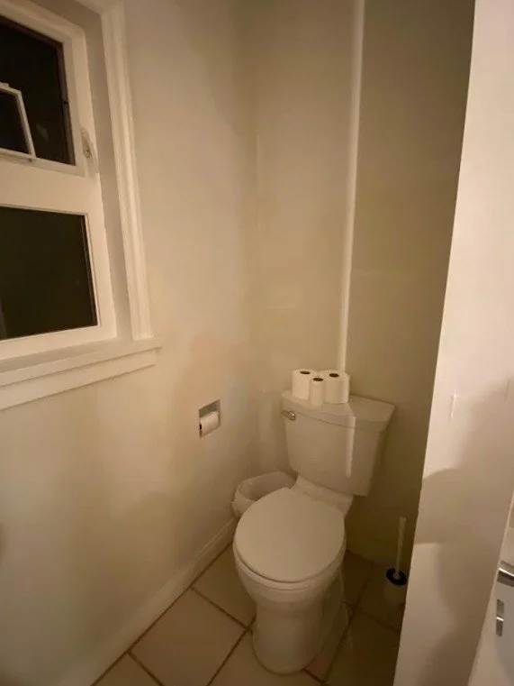 Ugly bathroom with peeling paint and washed out color. Blank walls leave this space looking unattractive.