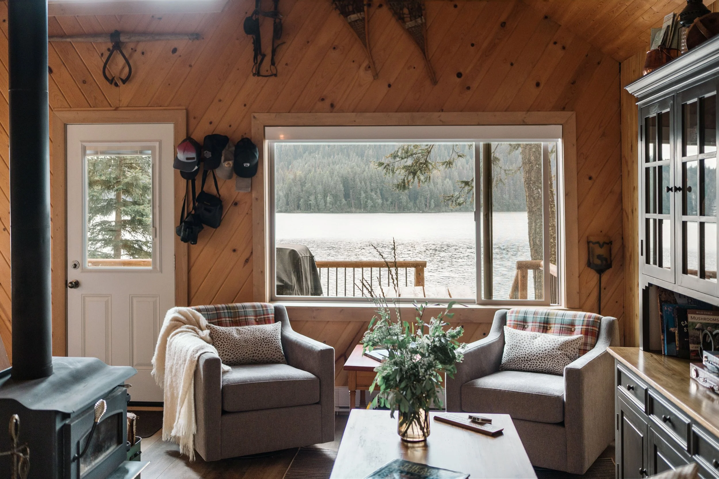 MCM Swivel Chairs with a custom upholstered plaid fabric on the inside of the chair backs. Rustic cabin with modern updates giving it a warm aesthetic.