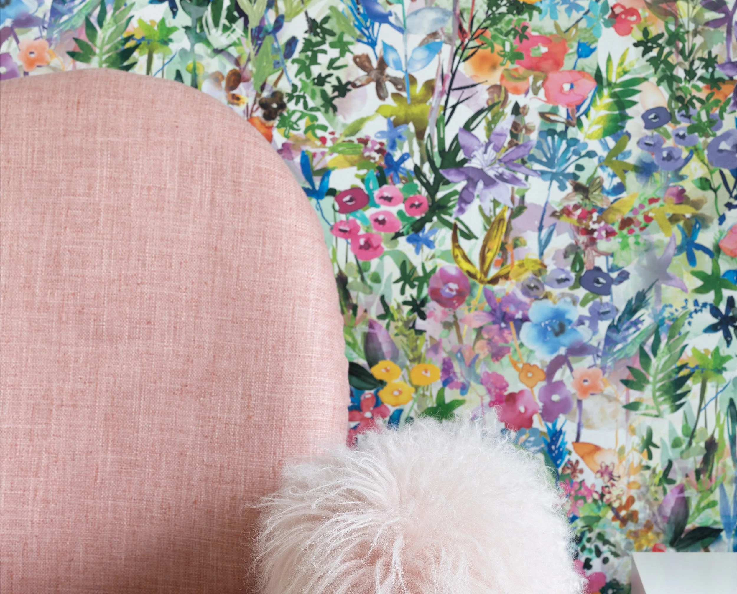 Pink office chair with Rebel Walls Poppy Meadow in Rainbow colorway