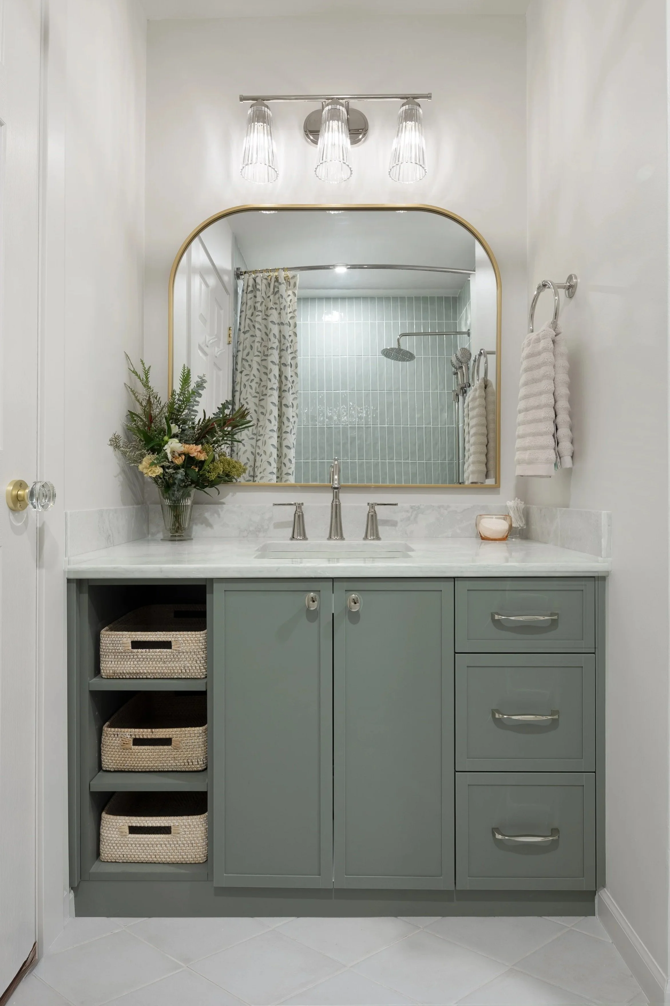 Bathroom After renovation. Chantilly Bathroom Vanity Savoy House 8-1745-3-109, Vicostone Esmeralda Vanity Counter, Eucalyptus green Vanity cabinet by Backbone Cabinet Solutions in North Vancouver. Wicker removeable drawers for easy access.