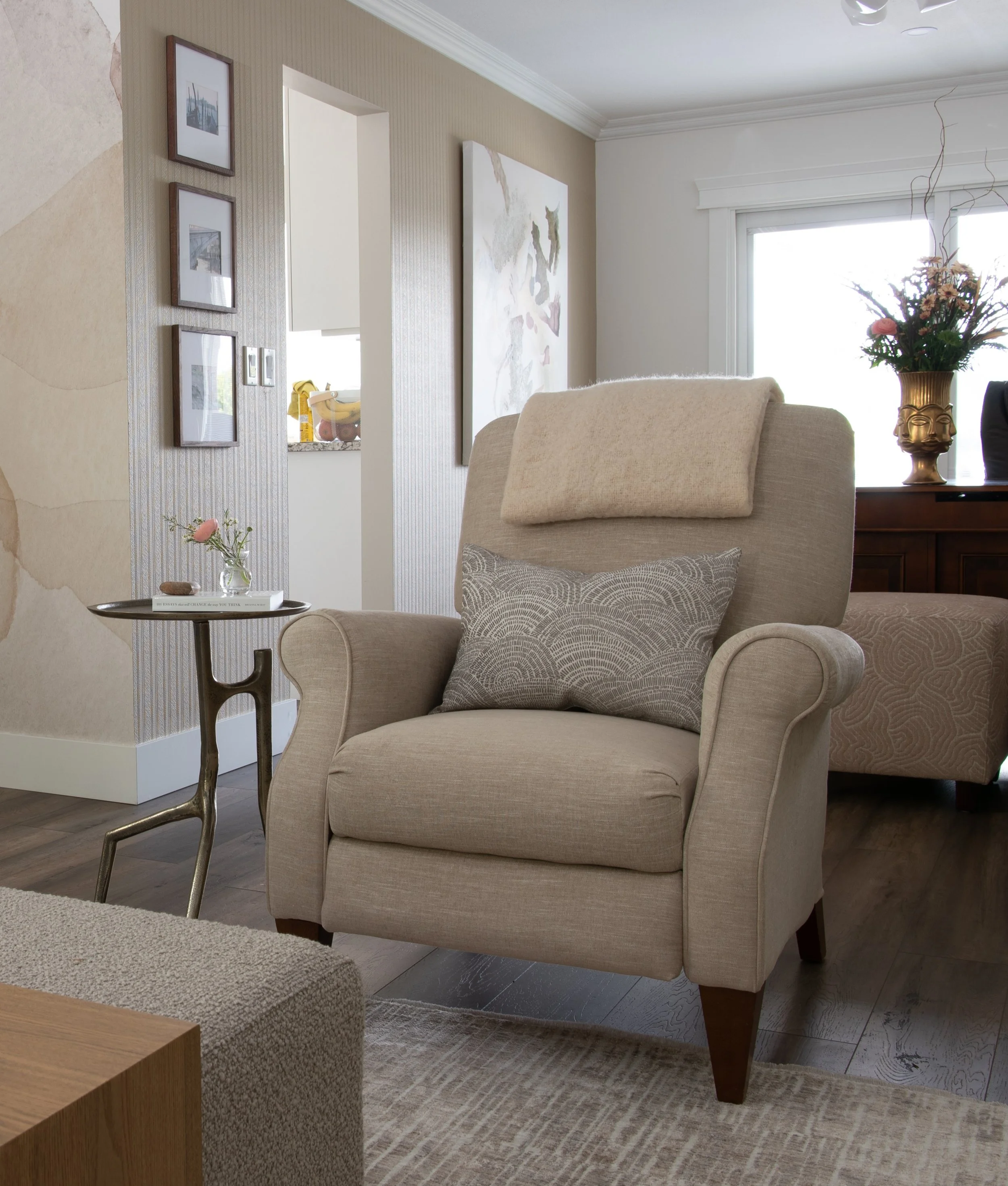 An "After Photo" of a traditional, rolled arm reclining armchair that has been reupholstered and received an update with new soft beige chenille fabric called Downie Wheat Kings