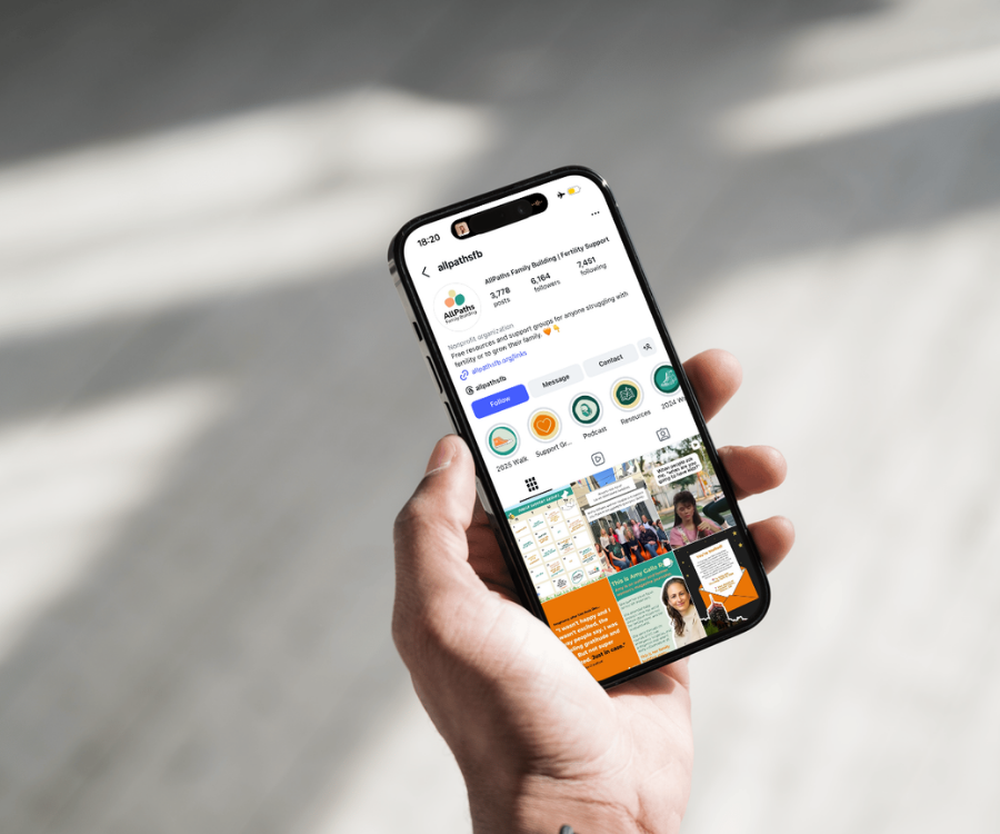 A person holding a smartphone displaying the Instagram page of AllPaths, a nonprofit organization supporting family building and infertility support groups.