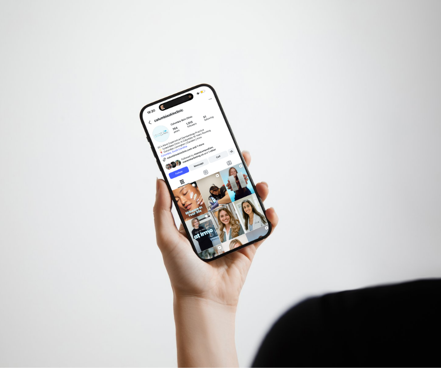 A person holding a smartphone displaying an Instagram profile page on a white background.