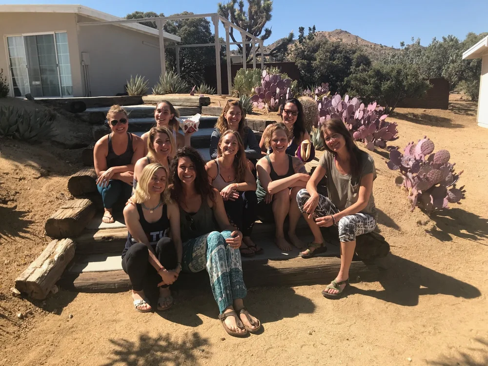 Retreat attendees sitting outside very happy