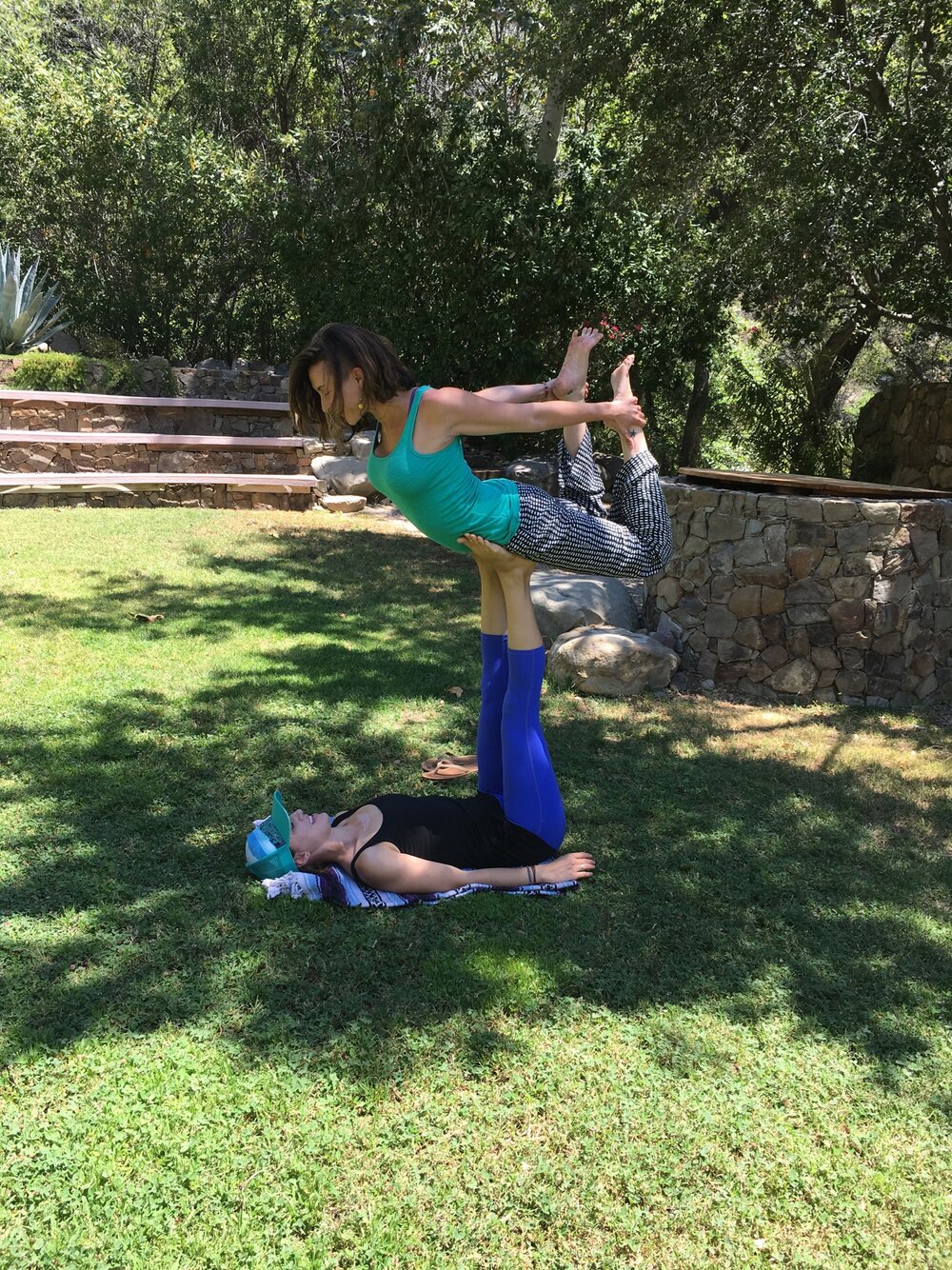 A woman lifting another using her feet