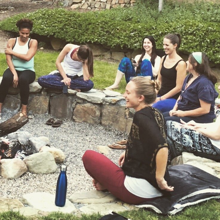 Retreat attendees sitting outside smiling