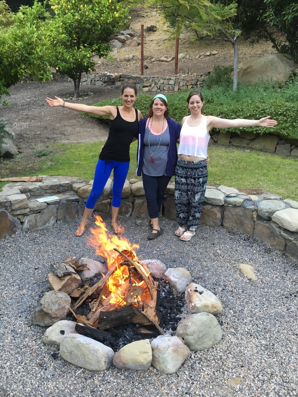 Retreat attendees happy next to a fire pit