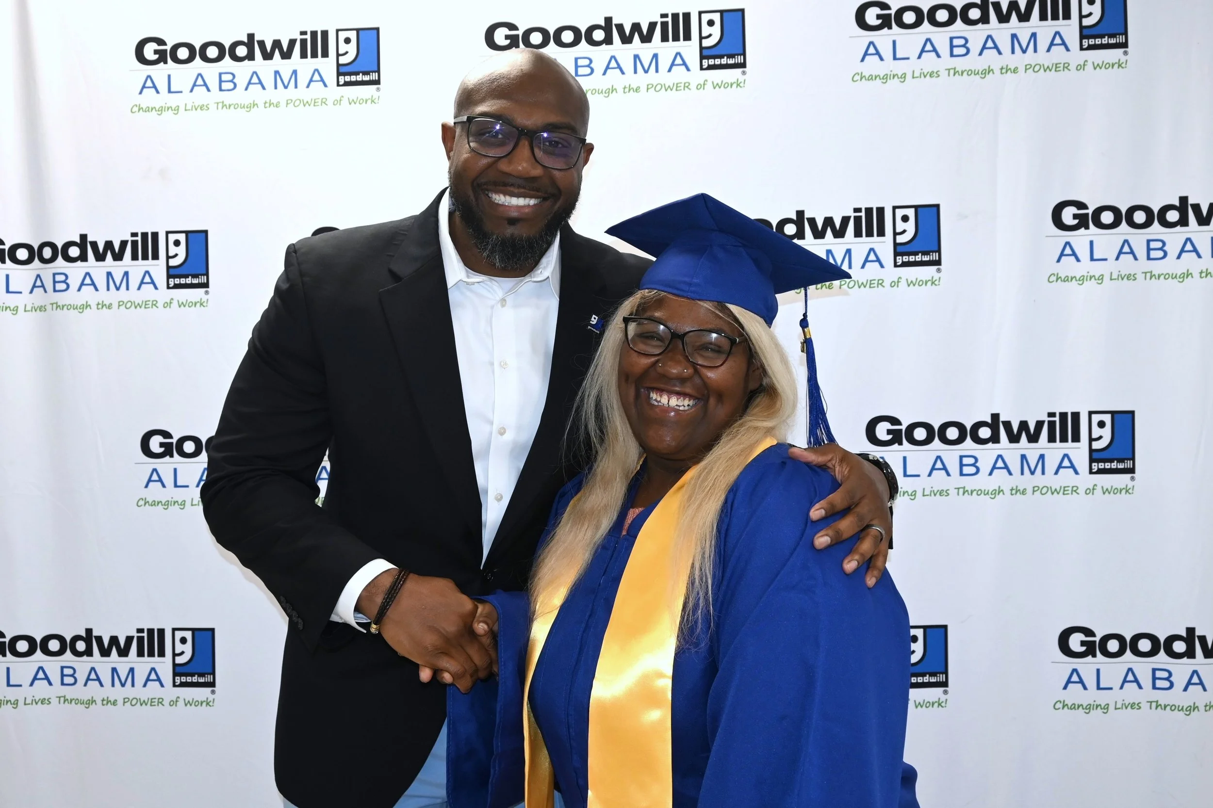 Alabama Goodwill President DeWayne Cuffie shaking hands with program graduate young lady