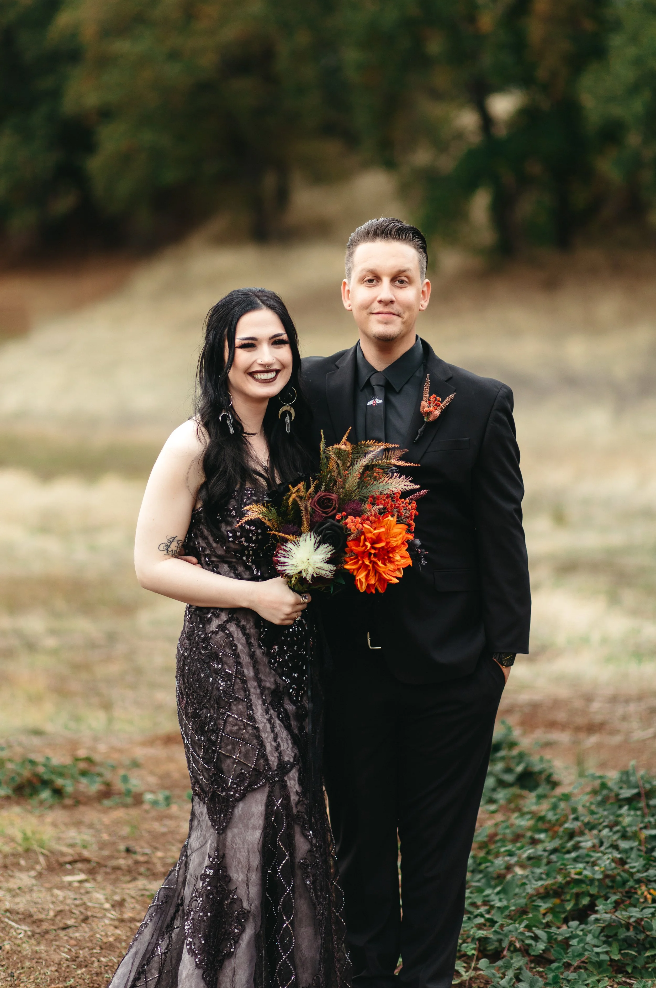 A Halloween Wedding Portrait of a bride and groom with a black dress