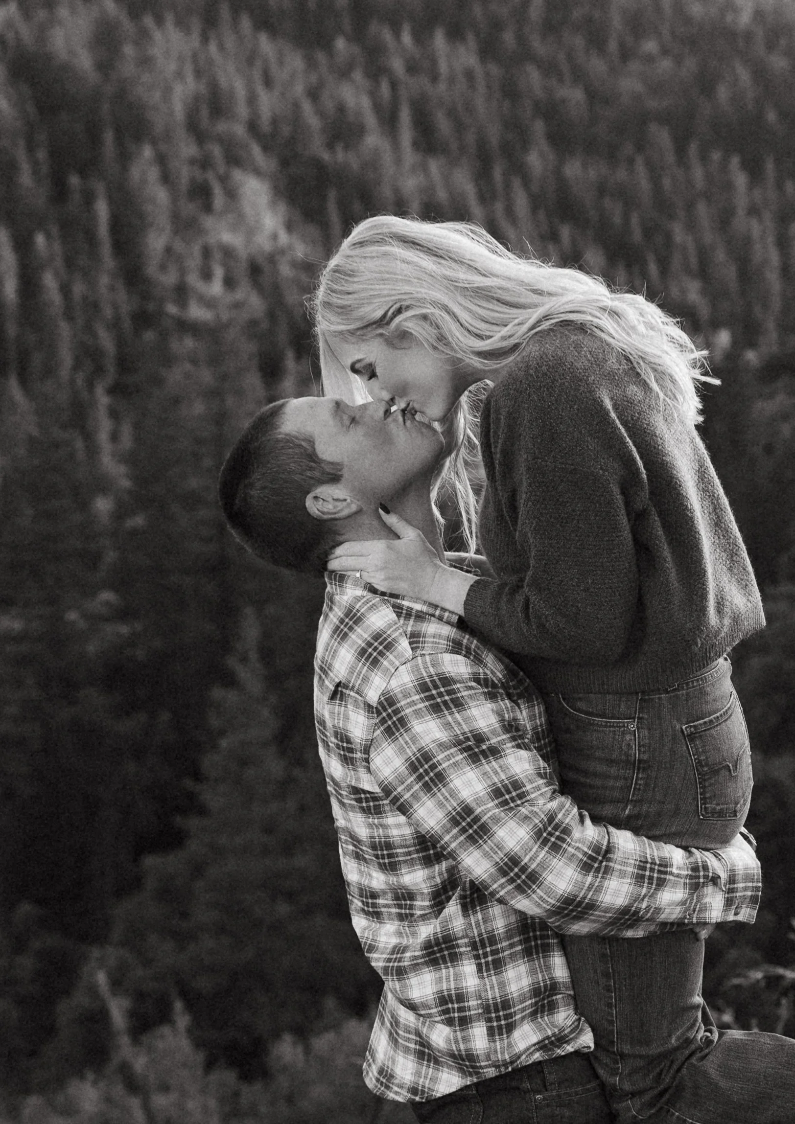 A couple sharing a mountain top kiss in Nevada City