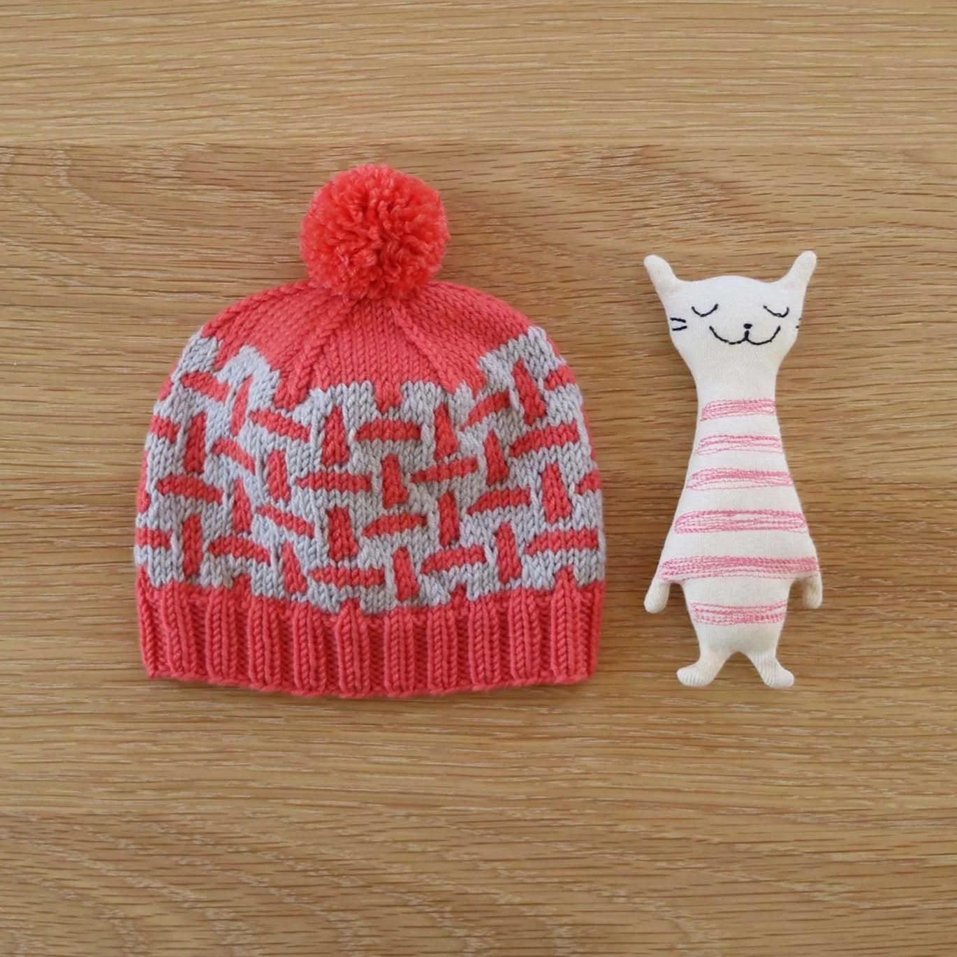 melon and pale grey baby acacia beanie with cat toy