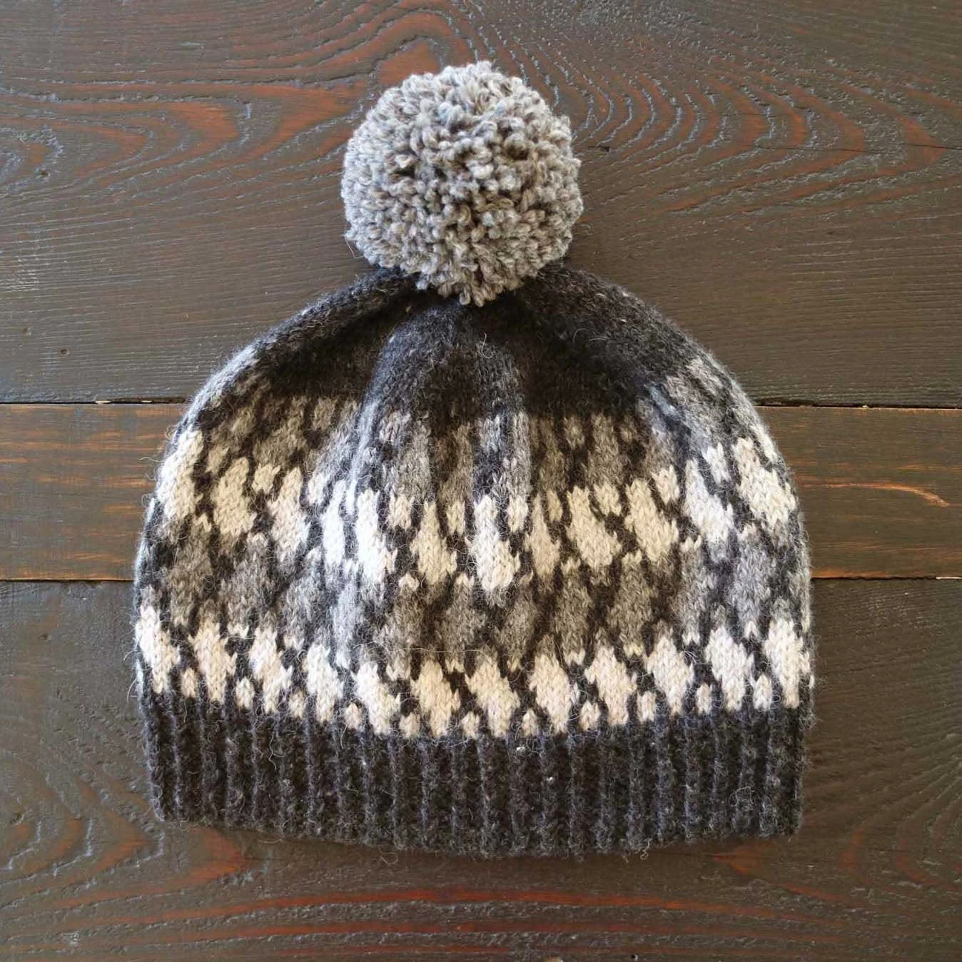 Colourwork knit beanie pattern in grey shades.