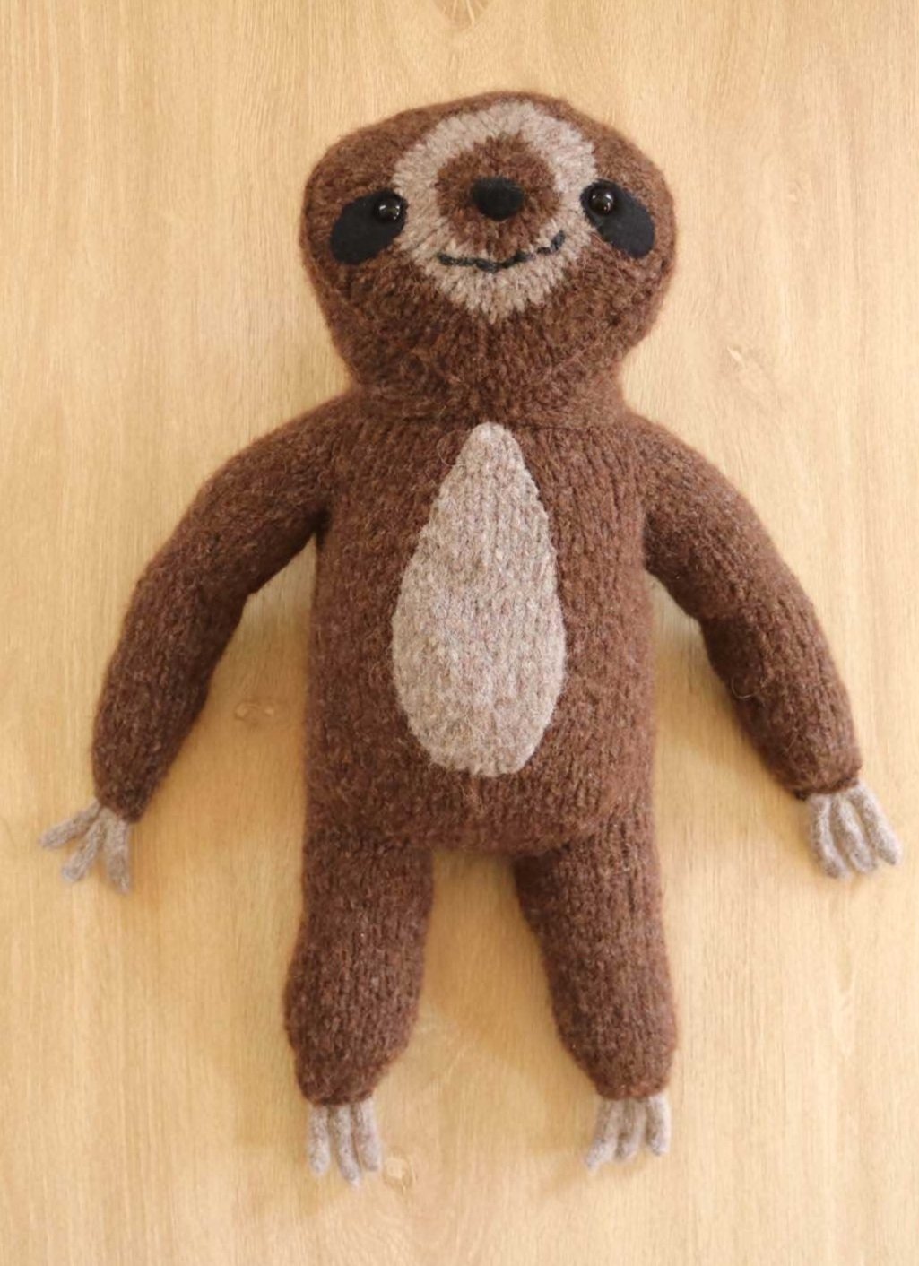 sloth knitted toy on table