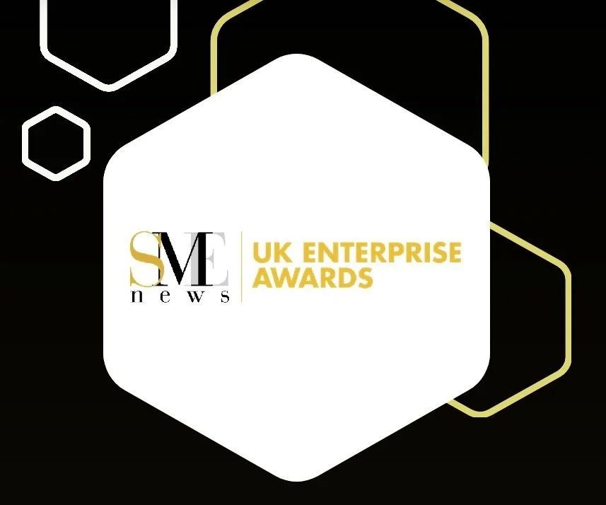 Logo for SM News UK Enterprise Awards featuring a black background with white and gold hexagonal shapes and text.