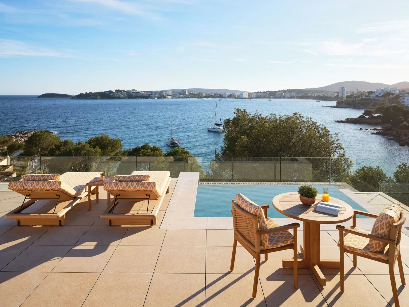 Terrace with plunge pool overlooking bay with city of Palma Mallorca across the other side