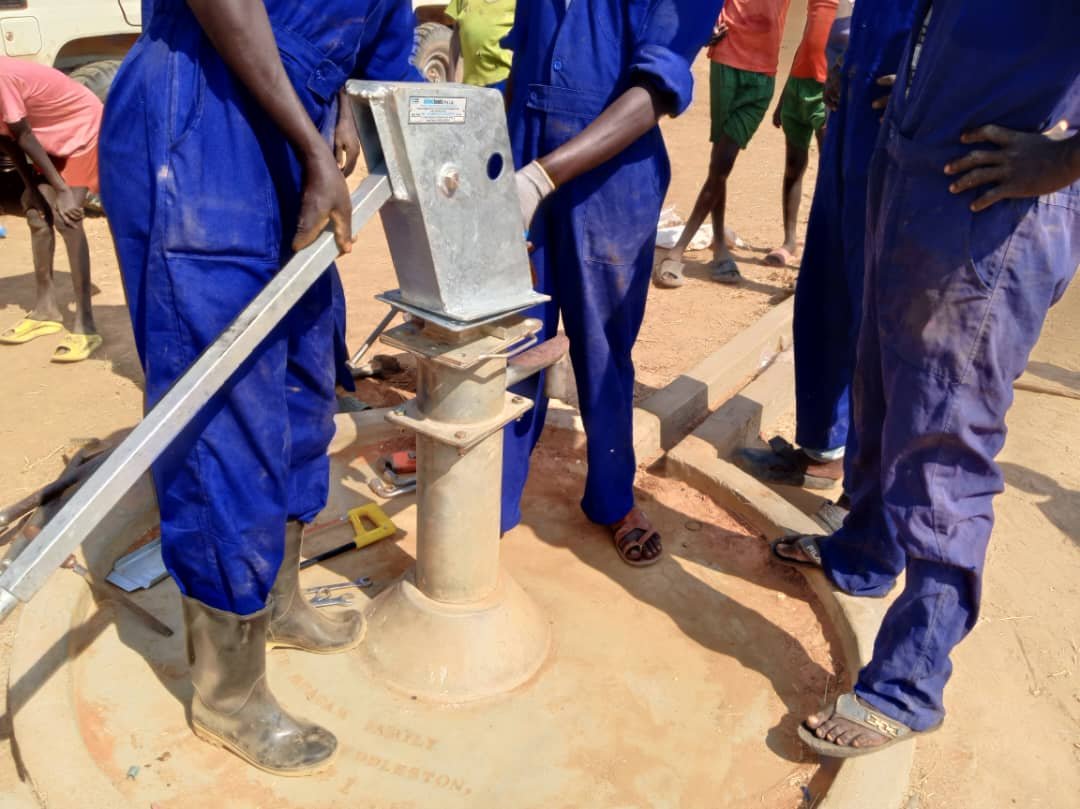 Presbyterian Day School setting up the handpump 4.jpg
