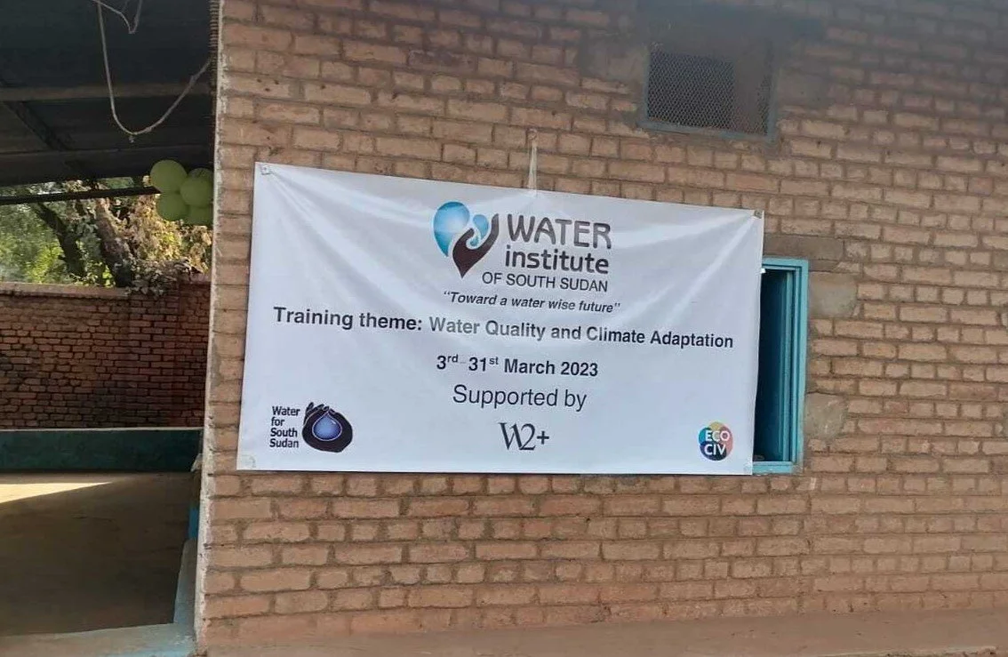 A white banner displaying the Water Institute of South Sudan. Training theme: Water Quality and Climate Adaptation. 3 - 31 March 2023. Supported by Water for South Sudan and W12+ Programs.