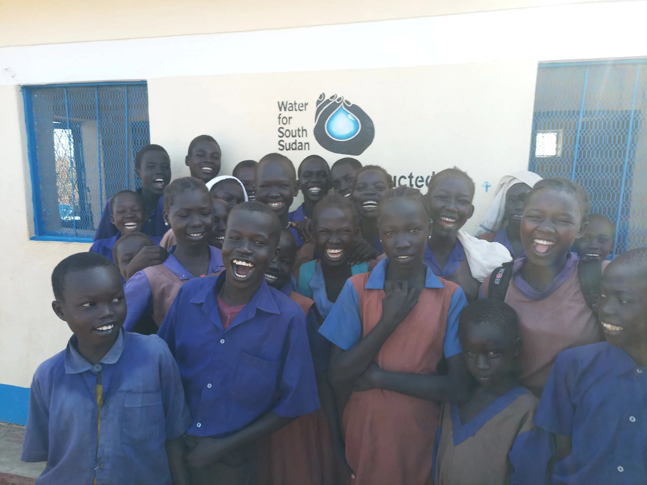 students in front of latrine