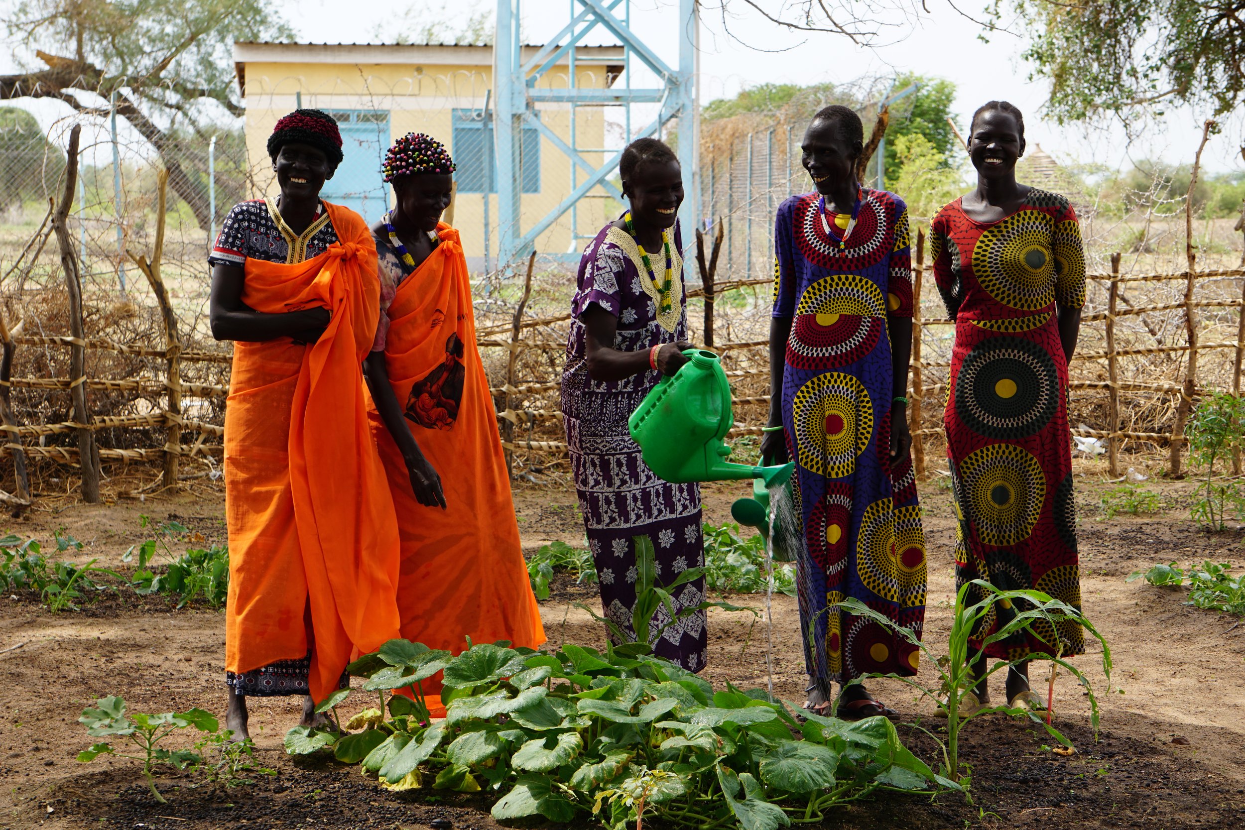 Group of women with watering cans.JPG