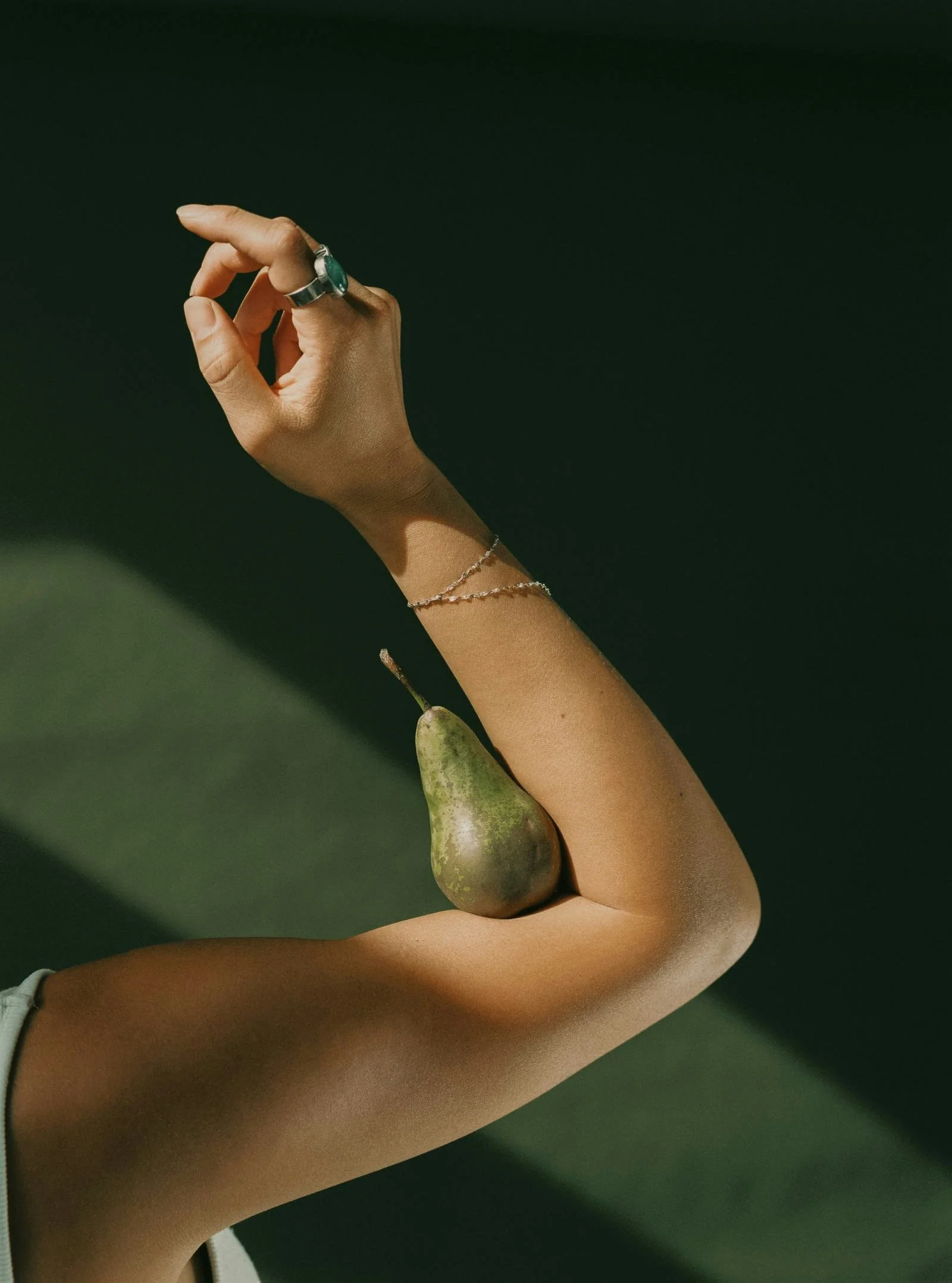 Woman practicing miWoman holding pear in arm during somatic therapy session in Brooklyn