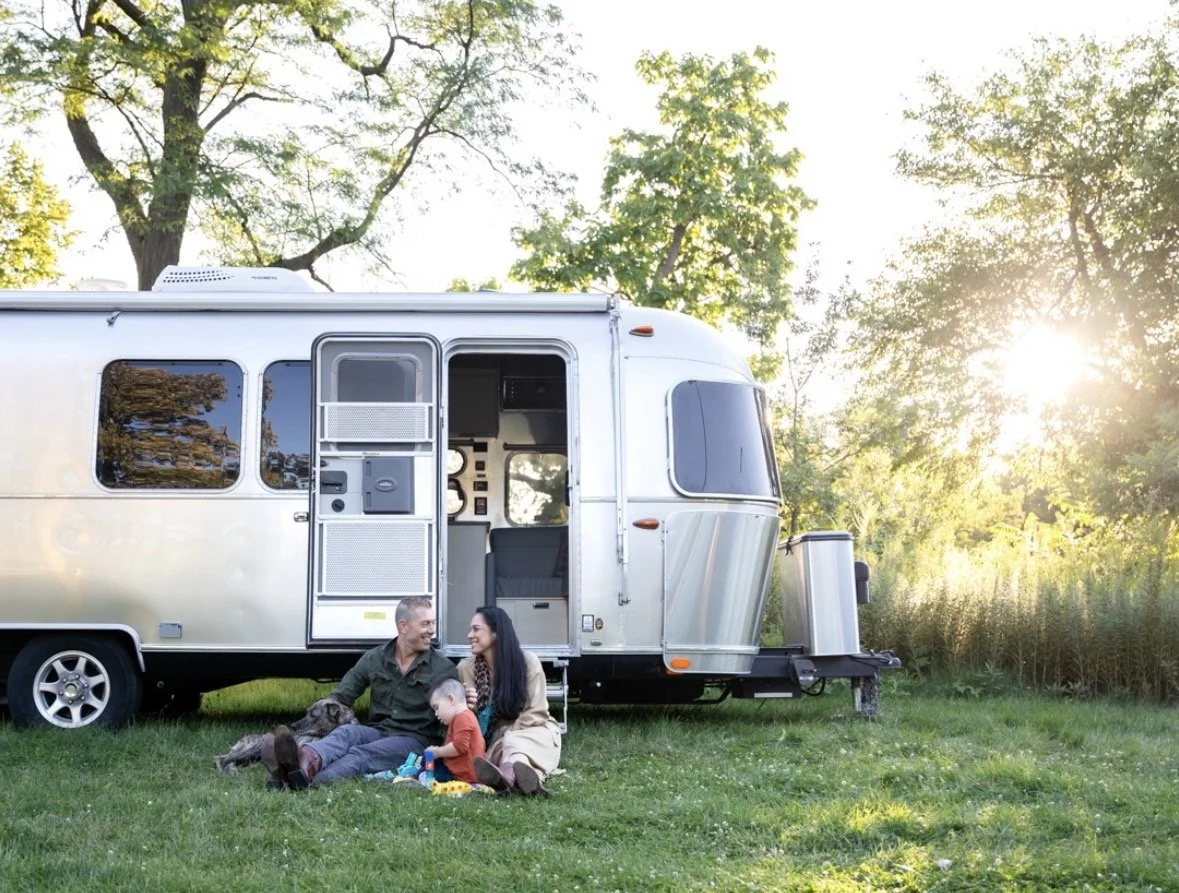 photo of a family outside a 28 foot airstream