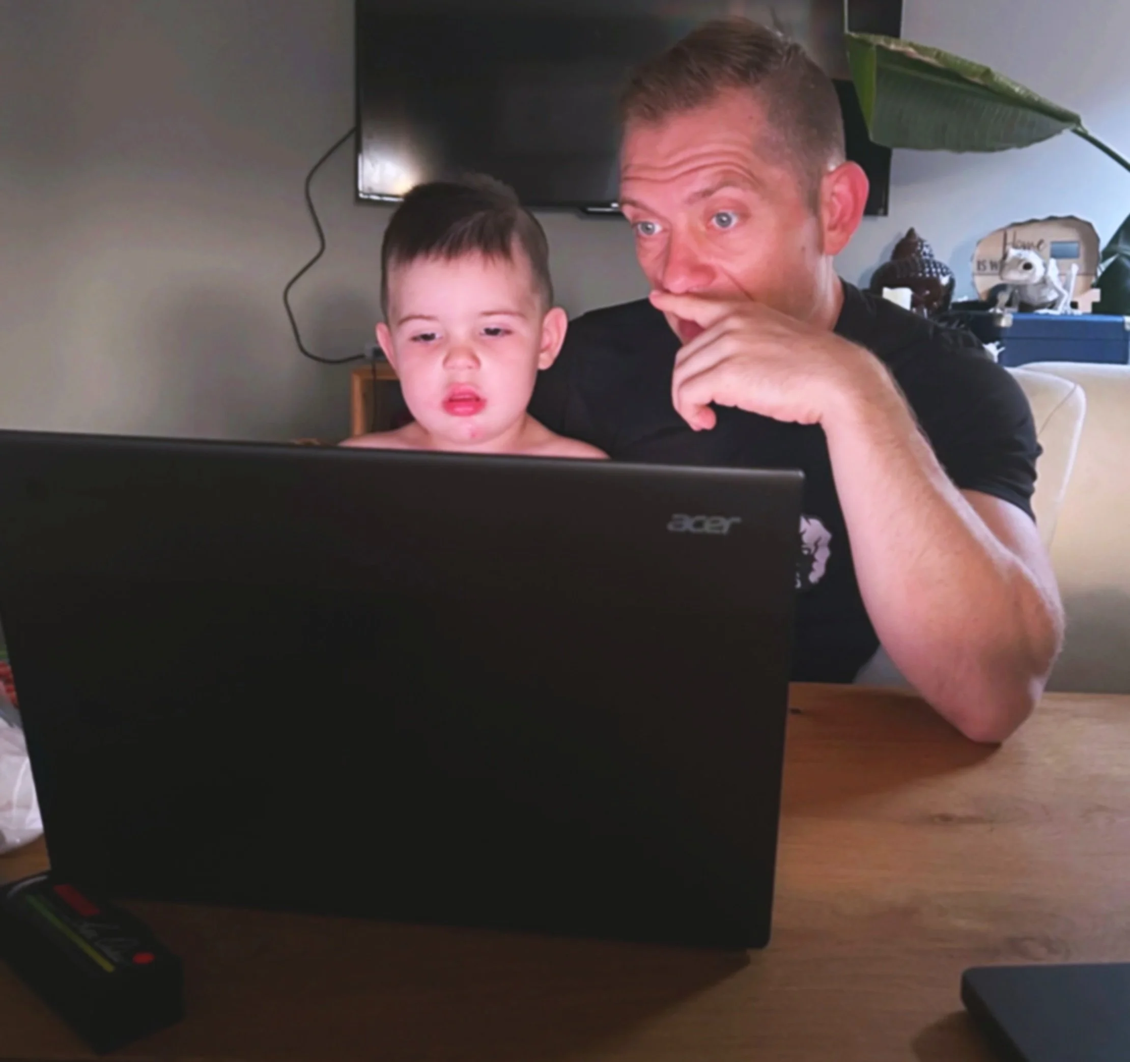 Father and son in front of a computer ready to send an email.