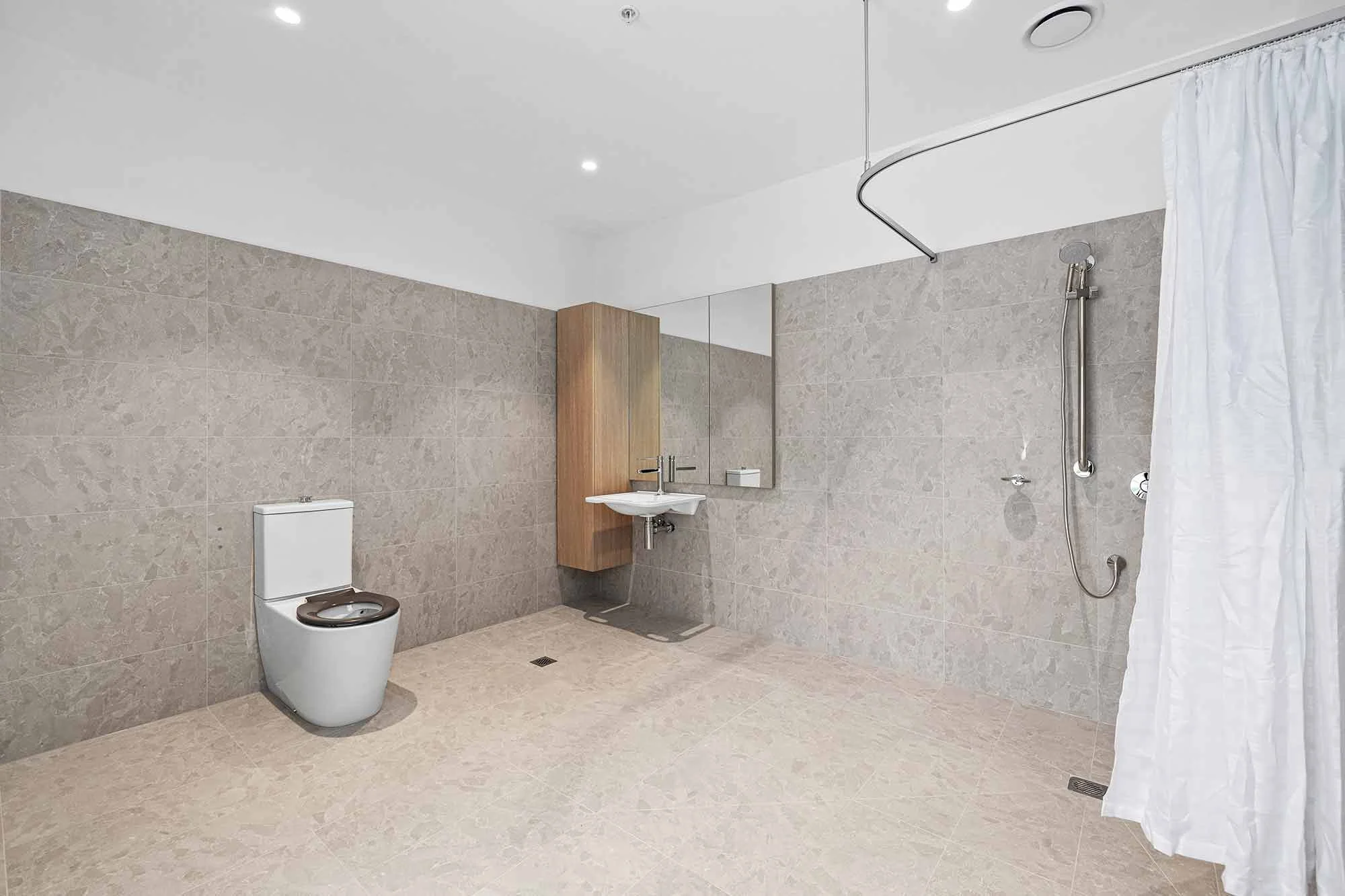 The accessible ensuite bathrooms at the Balmain and Co Rosebud SDA with the toilet, sink and shower in view