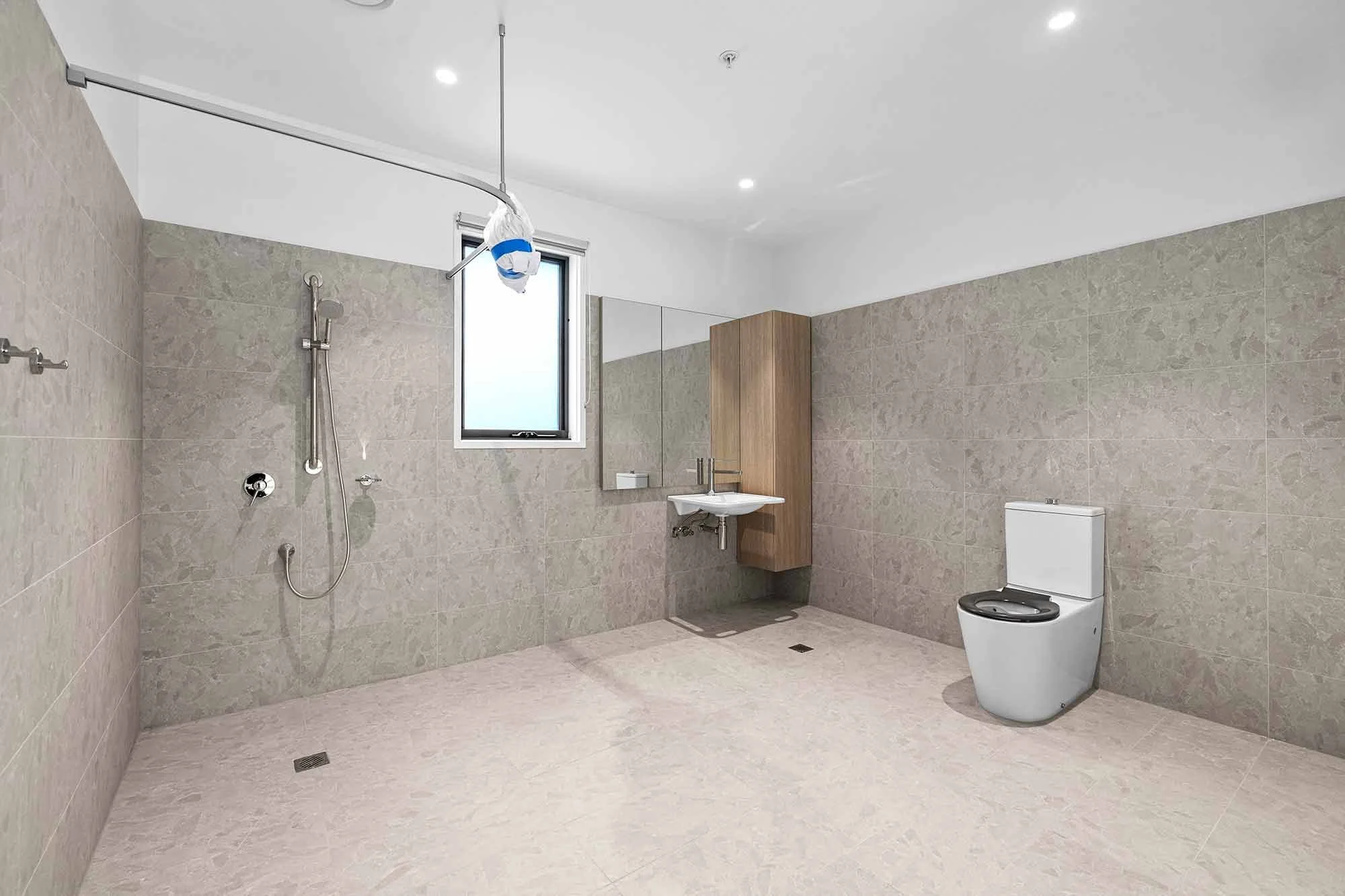 The accessible ensuite bathrooms at the Balmain and Co Rosebud SDA with the toilet, sink and shower in view