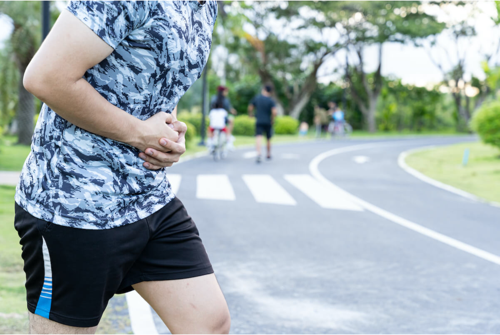 Runner holding stomach | JMD Copy