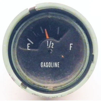 Vintage gasoline fuel gauge showing half full