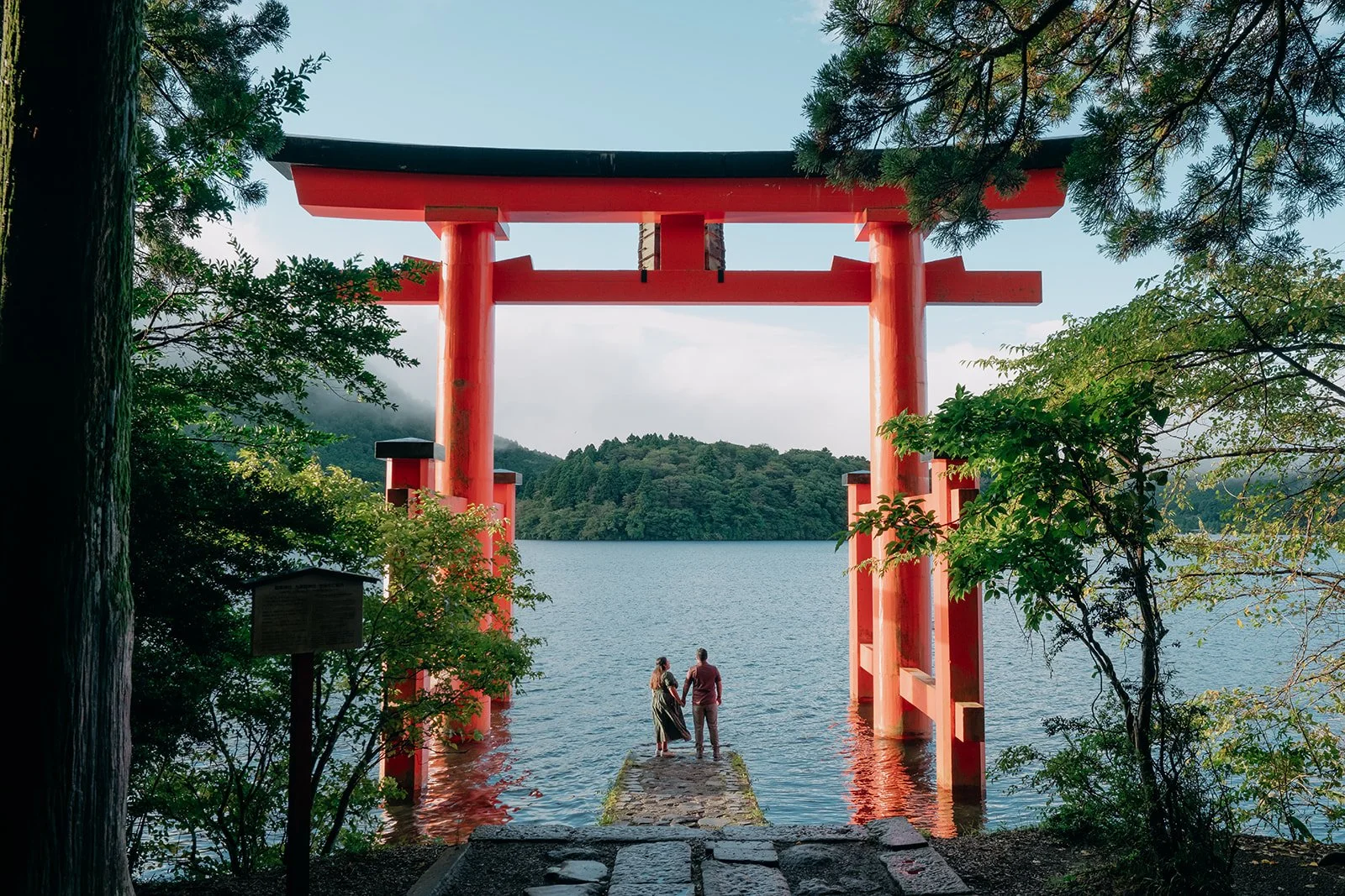 Natural couple interaction Hakone Shrine torii gate Japan