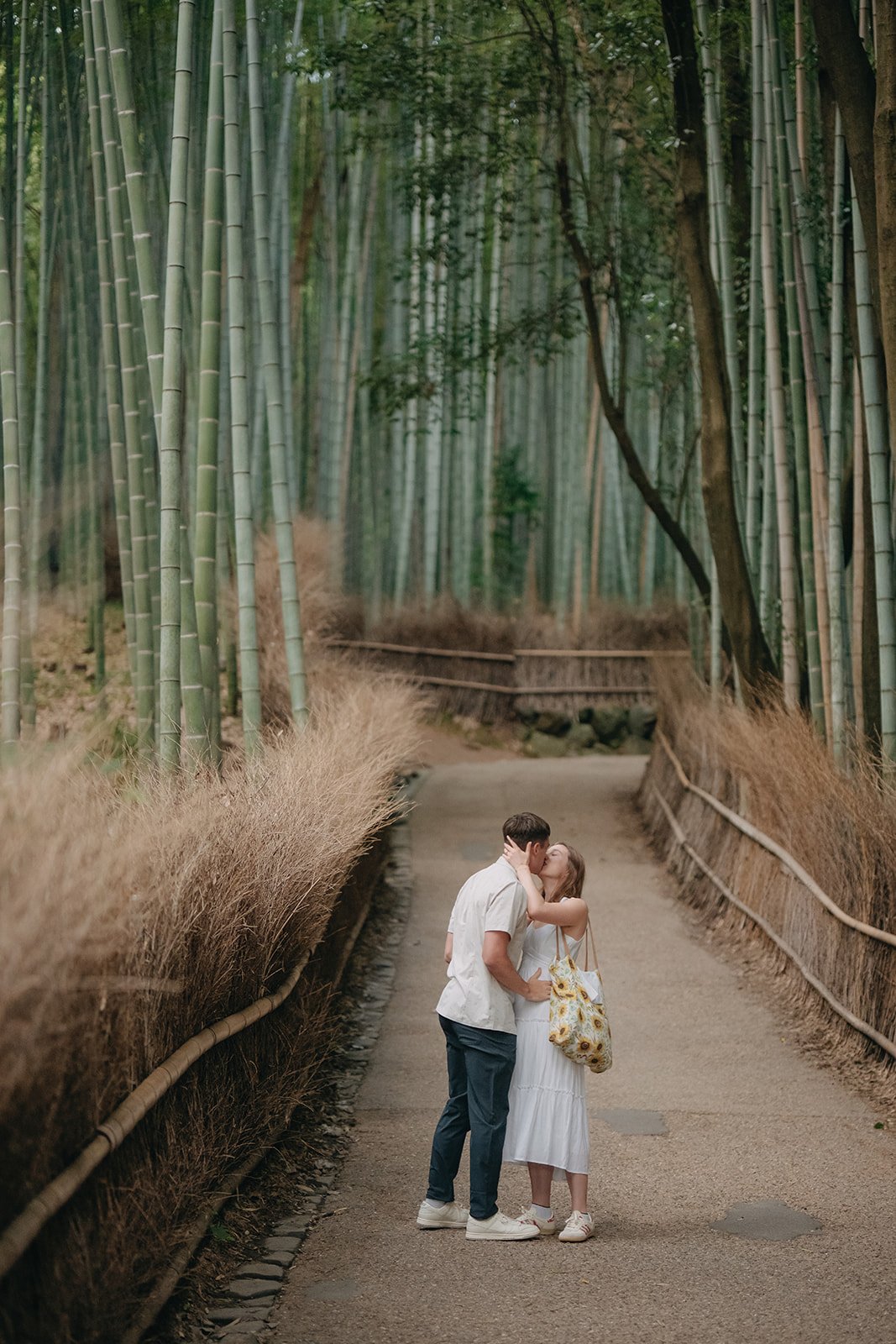Happy engaged couple Arashiyama Bamboo Forest Kyoto Japan