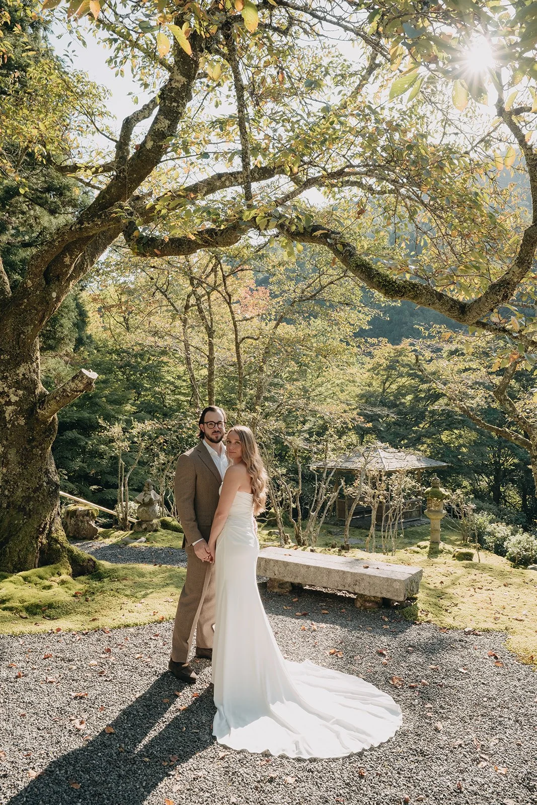 Wide shot of the couple in a Japanese garden, with the scenery around them