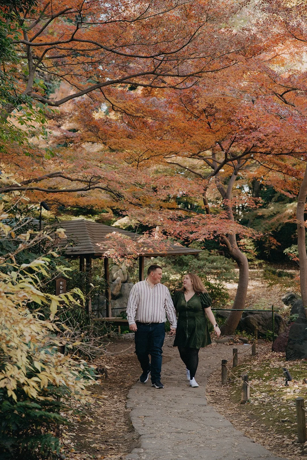Couple walking autumn paths Rikugien Garden Tokyo Japan morning