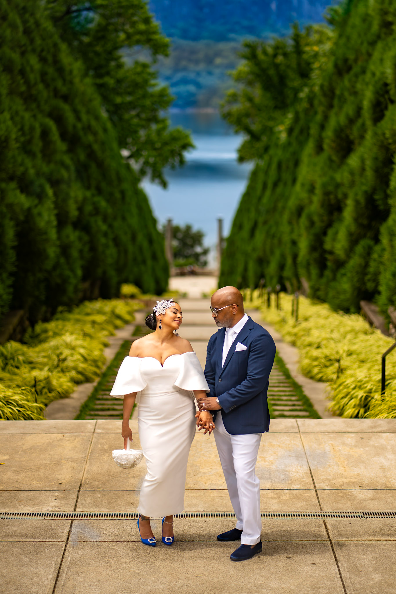 The couple during their upstate New York elopement. Her royal blue wedding shoes and his navy attire inspired the palette for their first-anniversary picnic.