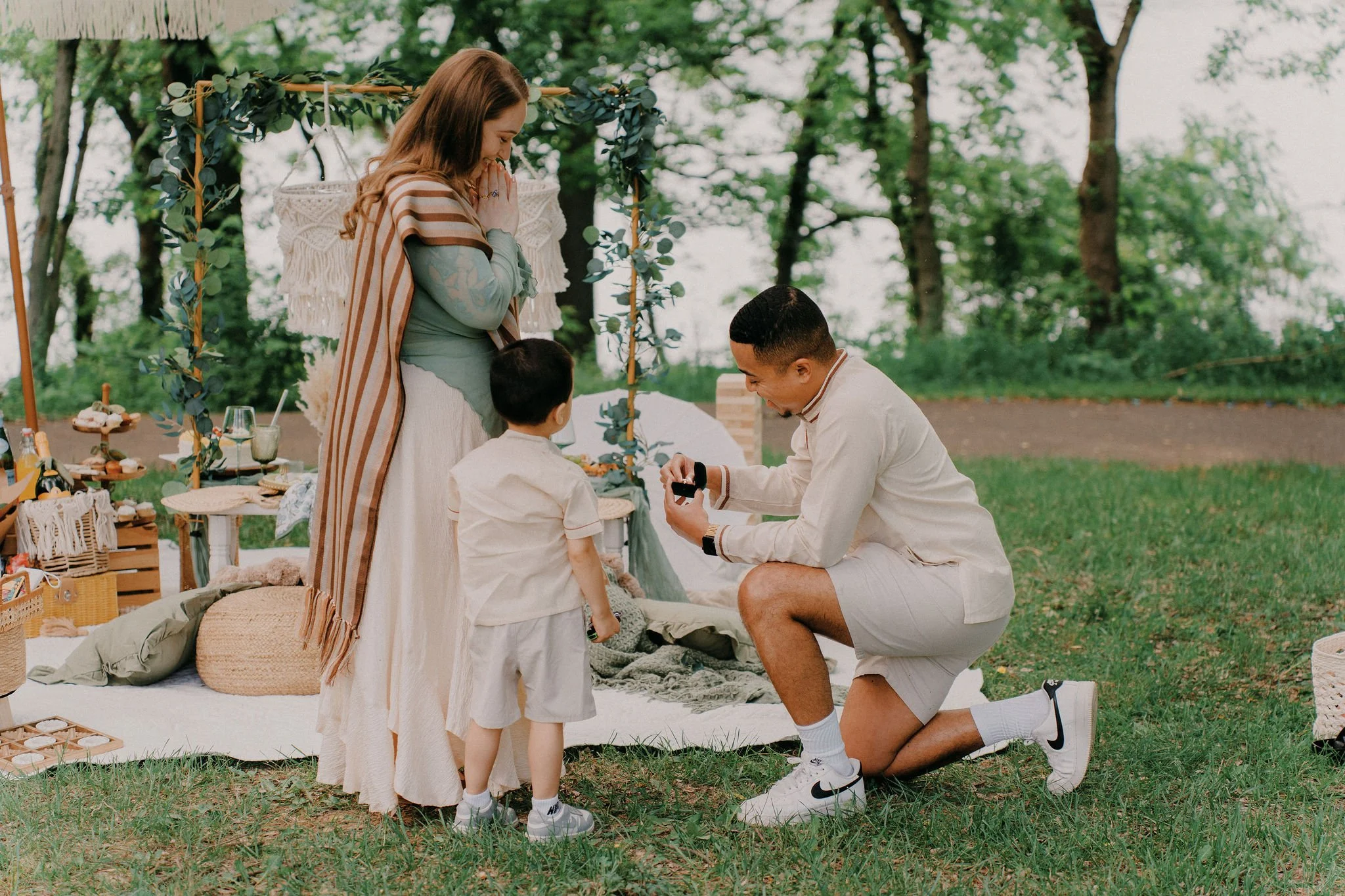Family Engagement Proposal Moment Man proposing beside his son at a luxury Maryland picnic