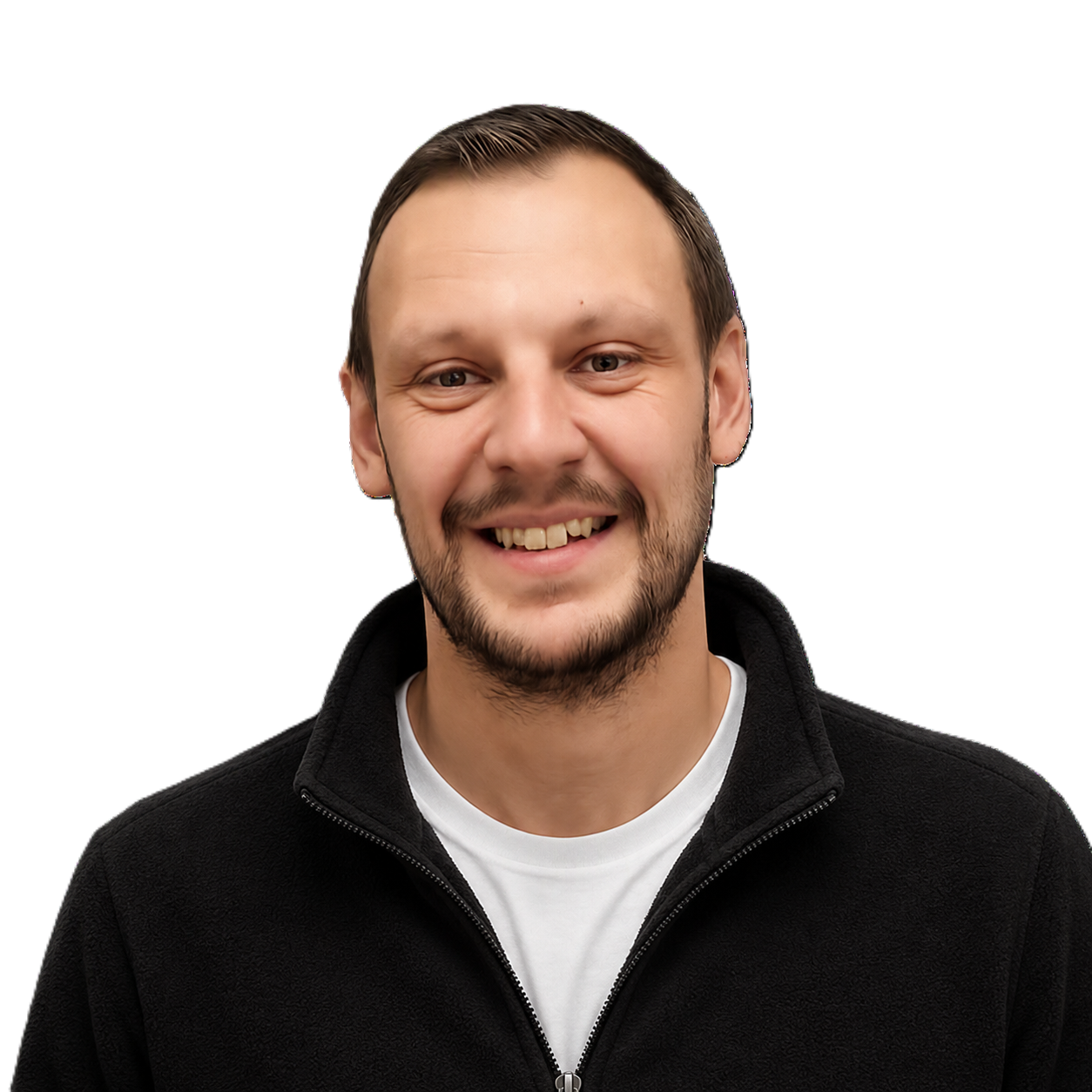 A young man with short dark hair, a beard, and light skin, smiling, wearing a black zip-up jacket over a white t-shirt, against a black background with a blue rectangle behind him.
