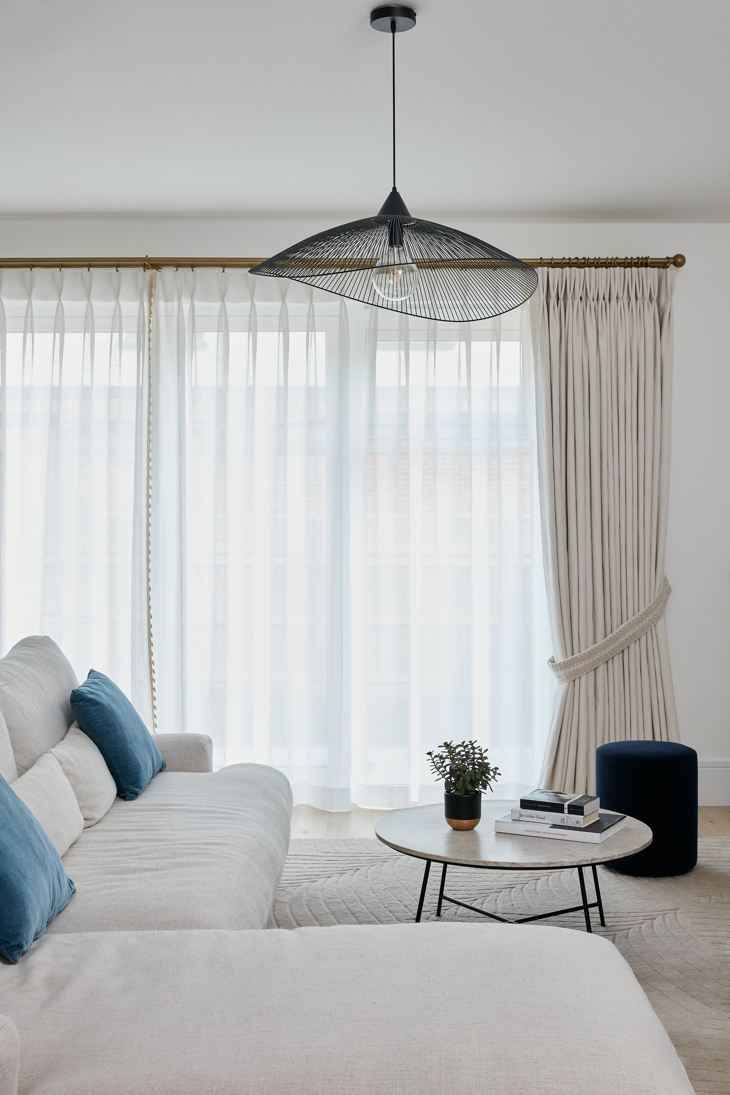 Photo of a living room with a double curtain and tieback