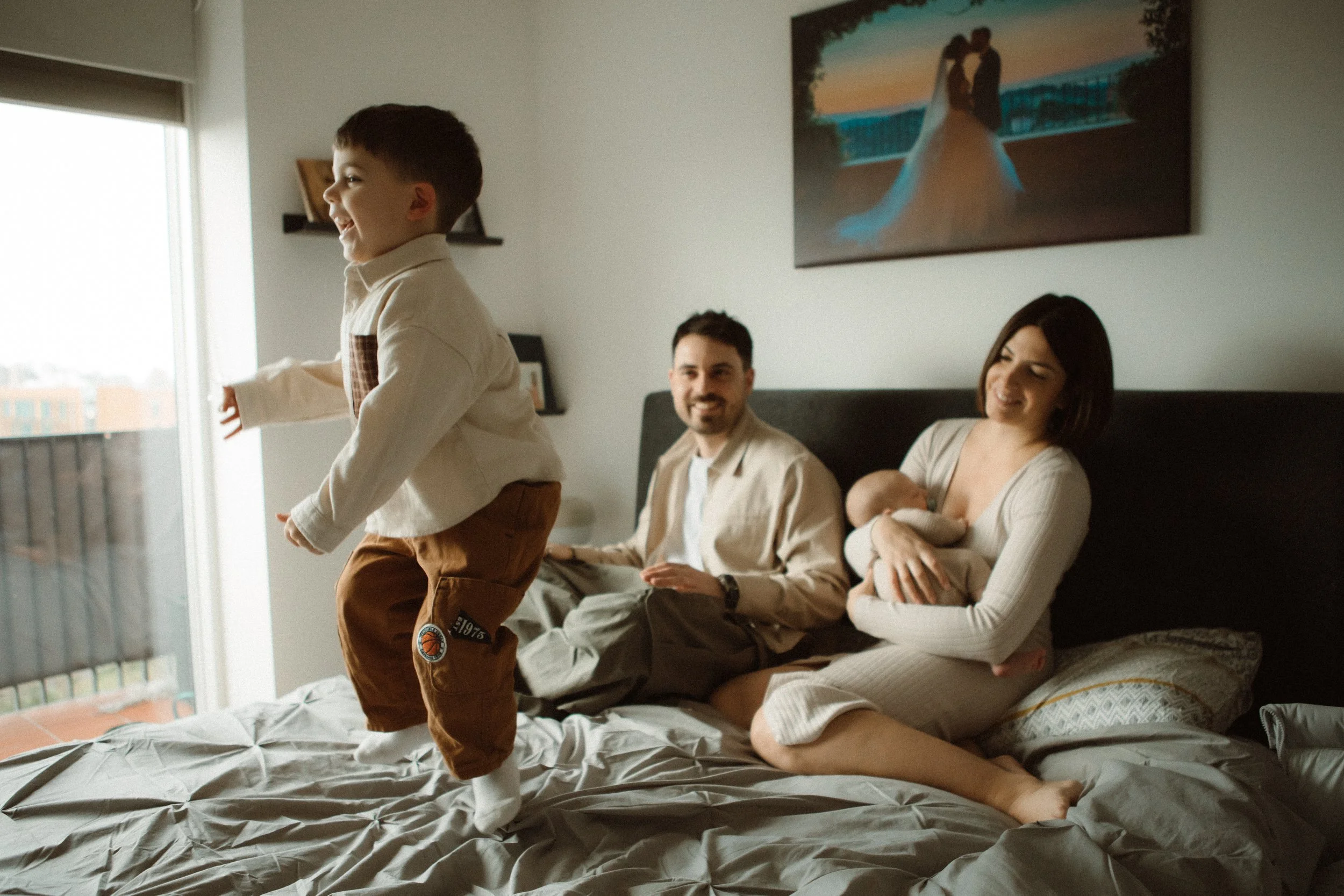 Mother  and Father with newborn baby and child during in-home family session, Southeast London